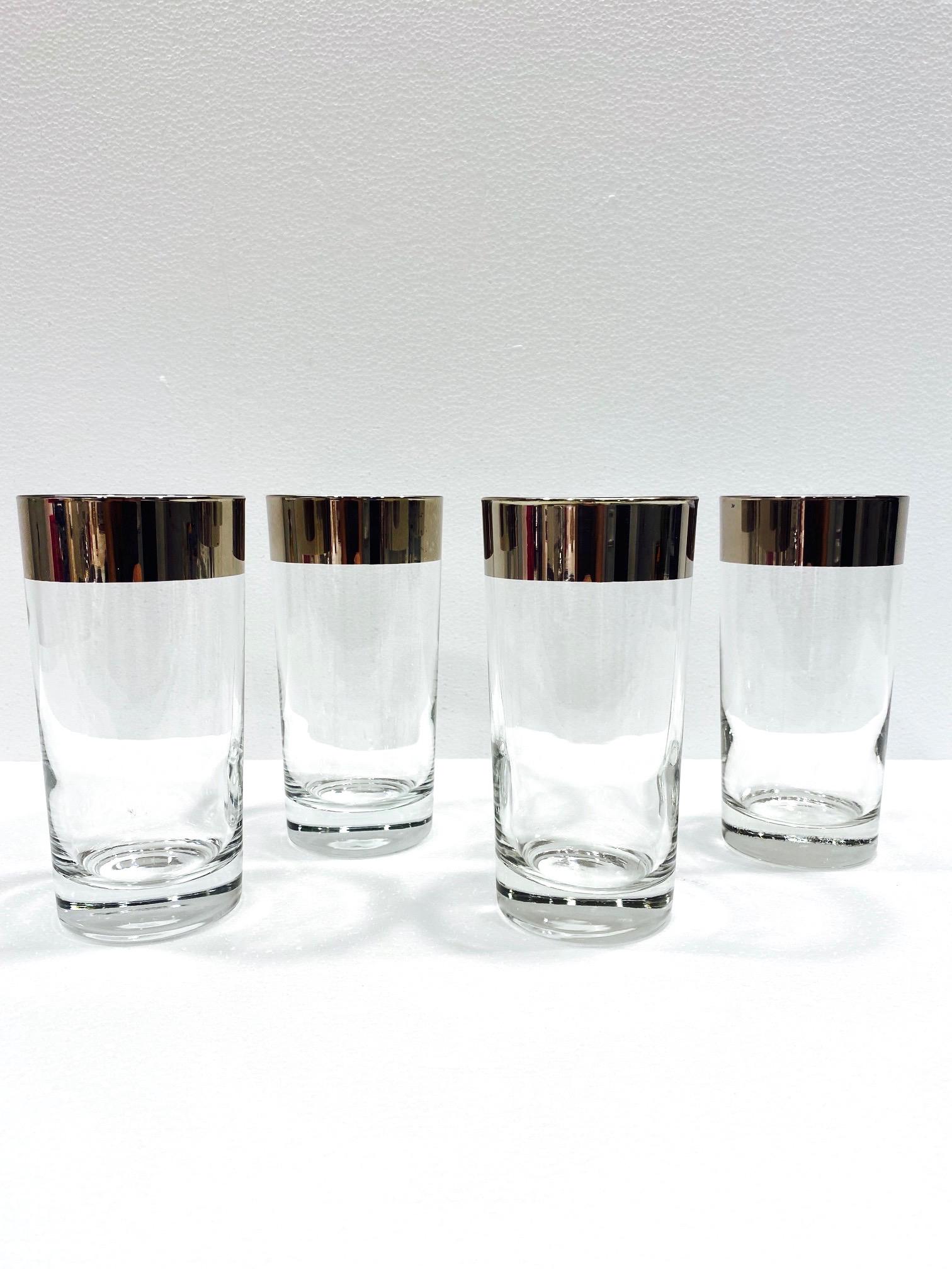 Set of four vintage highball or Tom Collins cocktail glasses. Barware glasses feature sleek cylinder form with the iconic silver rims for which Thorpe is recognized and highly sought after. These make an excellent and cheerful addition to any