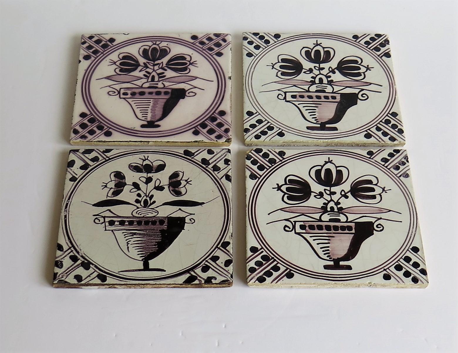 These are a SET of FOUR delft ceramic wall tiles, all with a very decorative manganese flower bowl pattern, made in the Netherlands and dating to the mid 19th century or possibly earlier.

The tiles are very decorative and nominally 5 inches square