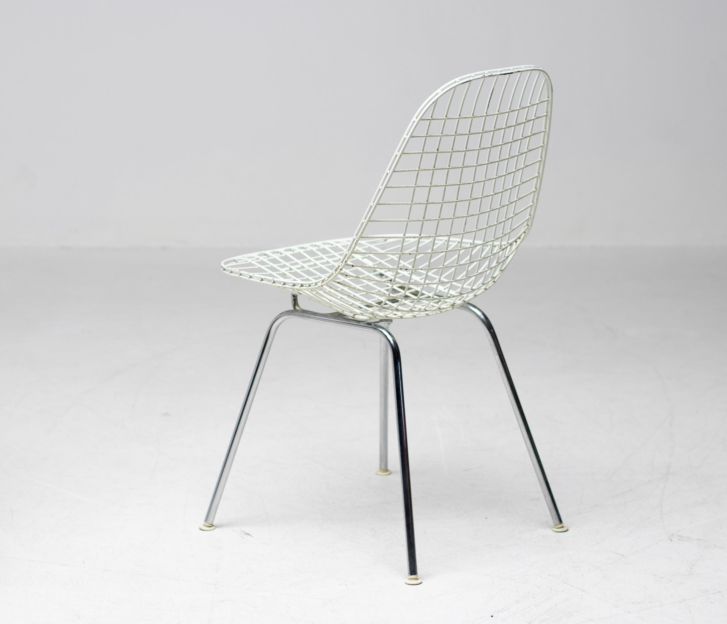 A set of four Eames DKR chairs for Herman Miller. The frame for these chairs is made of a steel wires welded together, powder coated white on a chromed steel 4 leg base. The Bikini pad coverings are the original Herman Miller designed by Alexander