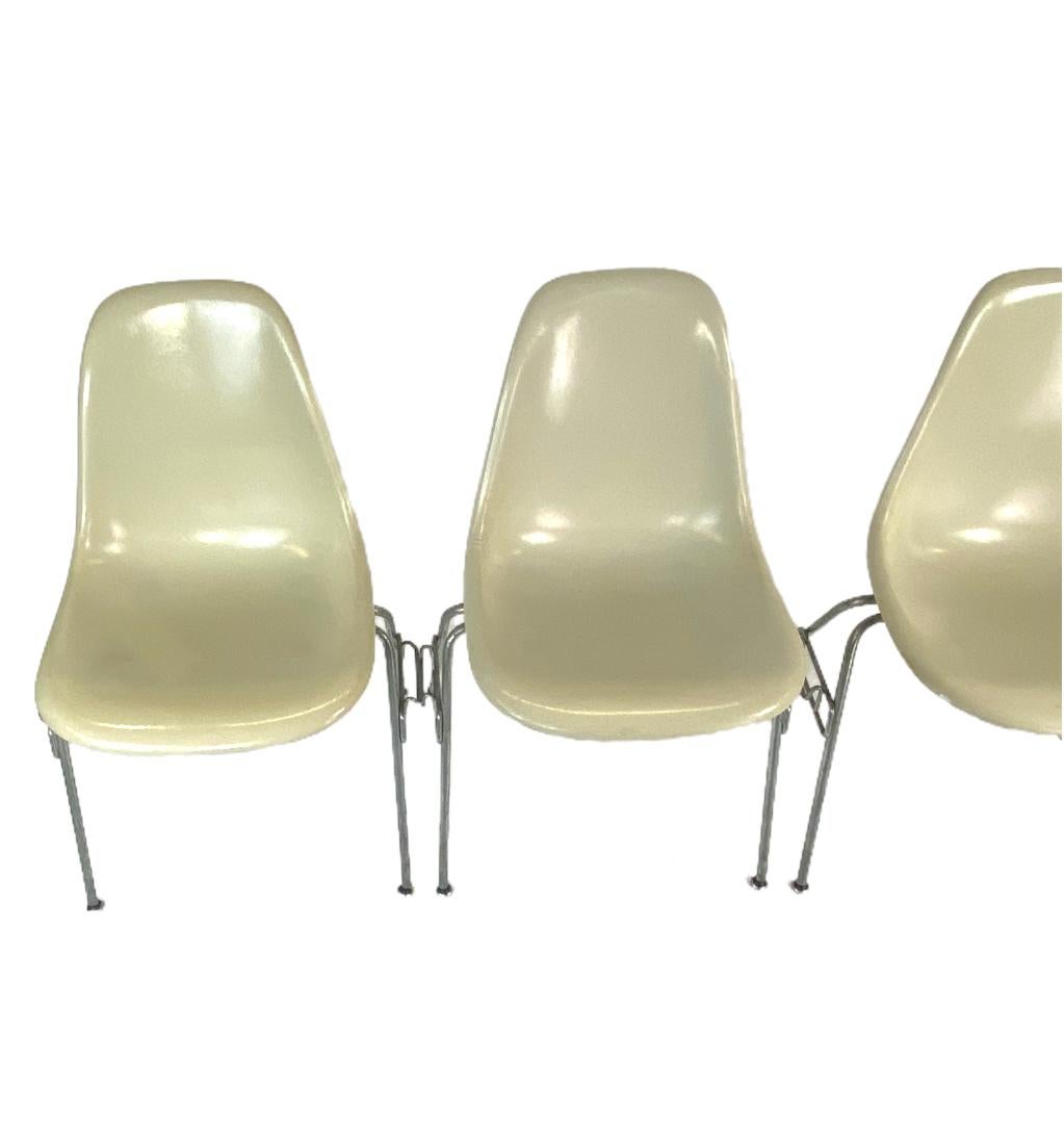 Vlasic set of 4 stacking Herman Miller Eames fiberglass chairs. Dining height set in parchment color. In original condition with patina and wear for the age. These are not sanded and glossed like many overdone chairs. These are for the buyer who