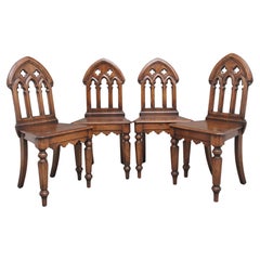 Set of four early 20th Century Gothic style hall chairs