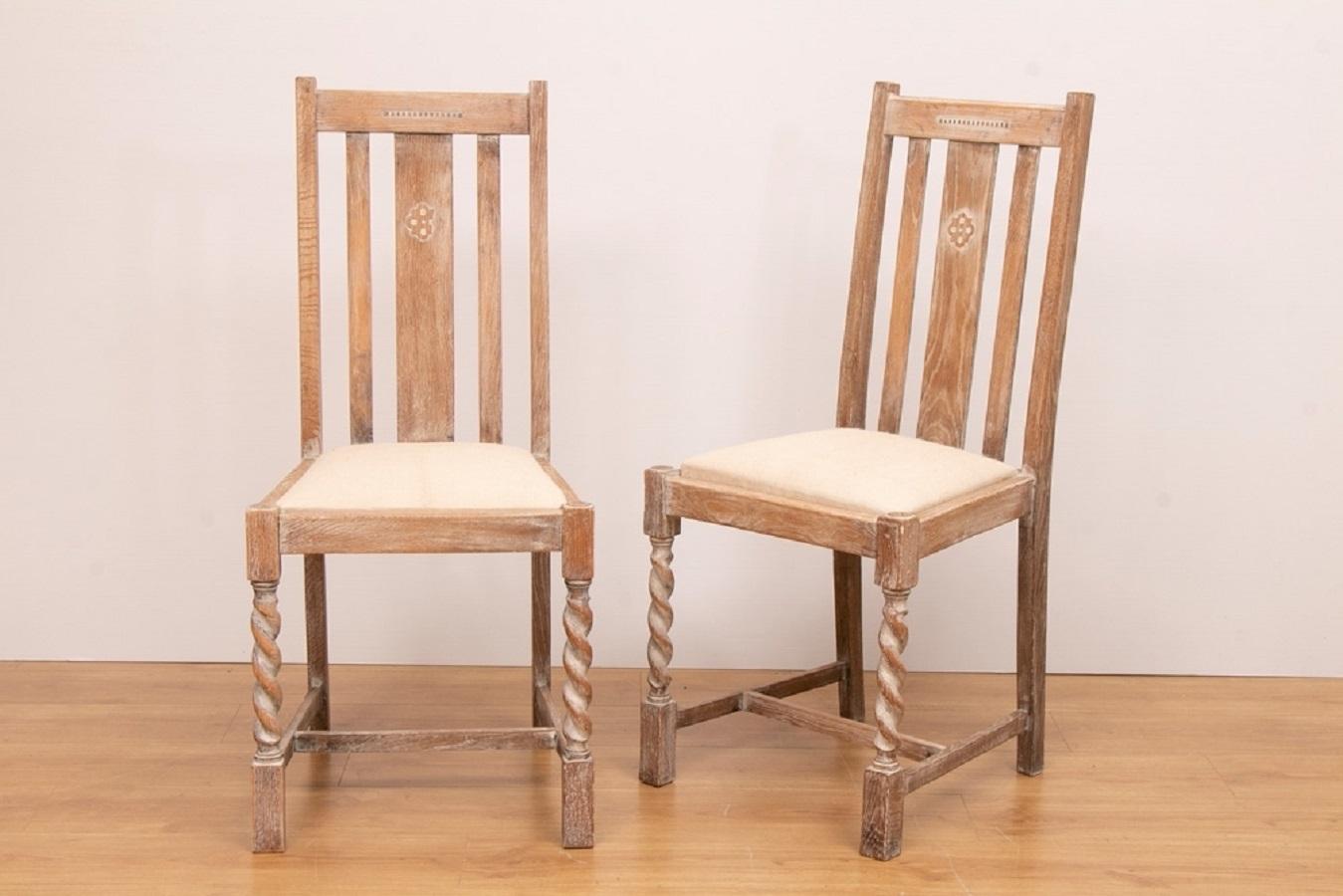 A set of four early 20th century limed oak frame dining chairs with barley twist legs and linen upholstered seats.

Measures: H: 100cm, W: 45cm, D: 47cm, seat height: 50cm.
