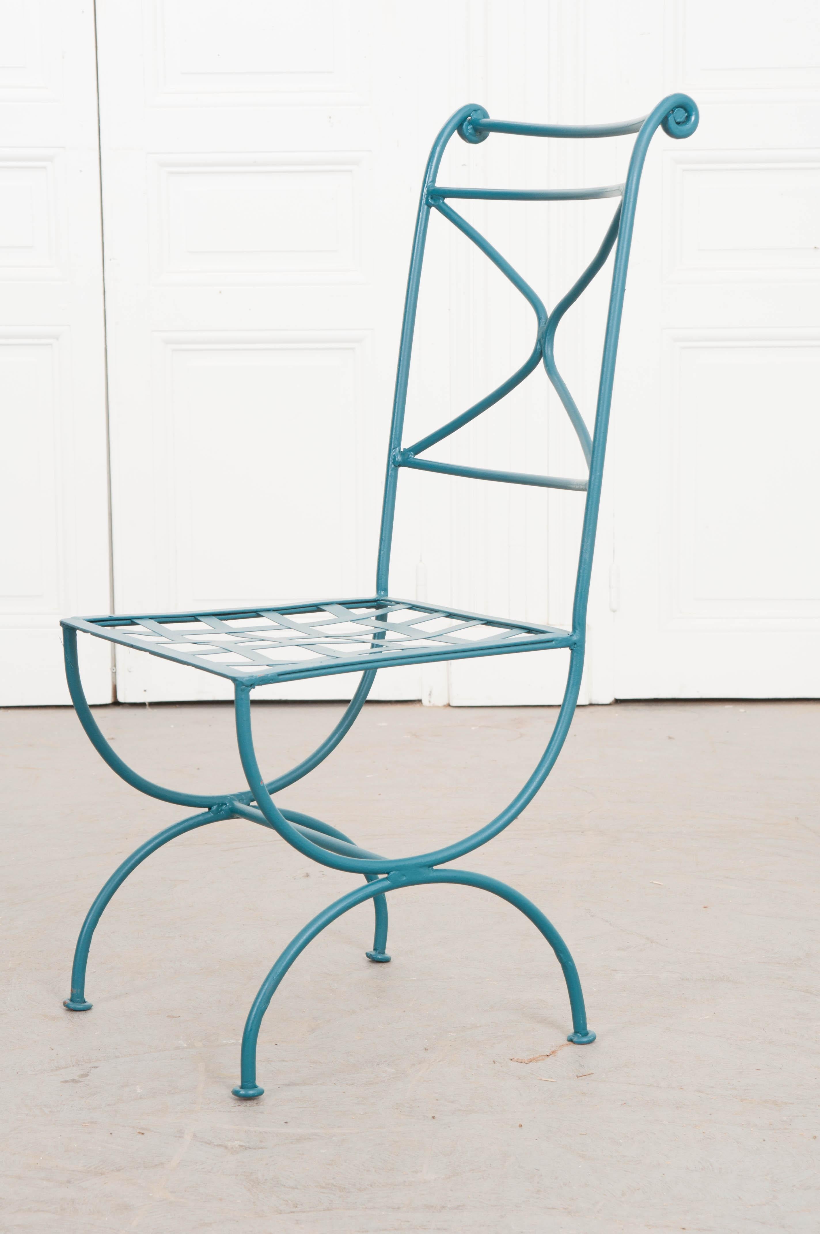 This elegant suite of four verdigris-painted wrought iron side chairs, of the Classic Curule-form, are from France, circa 1900. The X-form chair-backs echo the Curule-style legs. Since they are made of wrought iron, these chairs would work