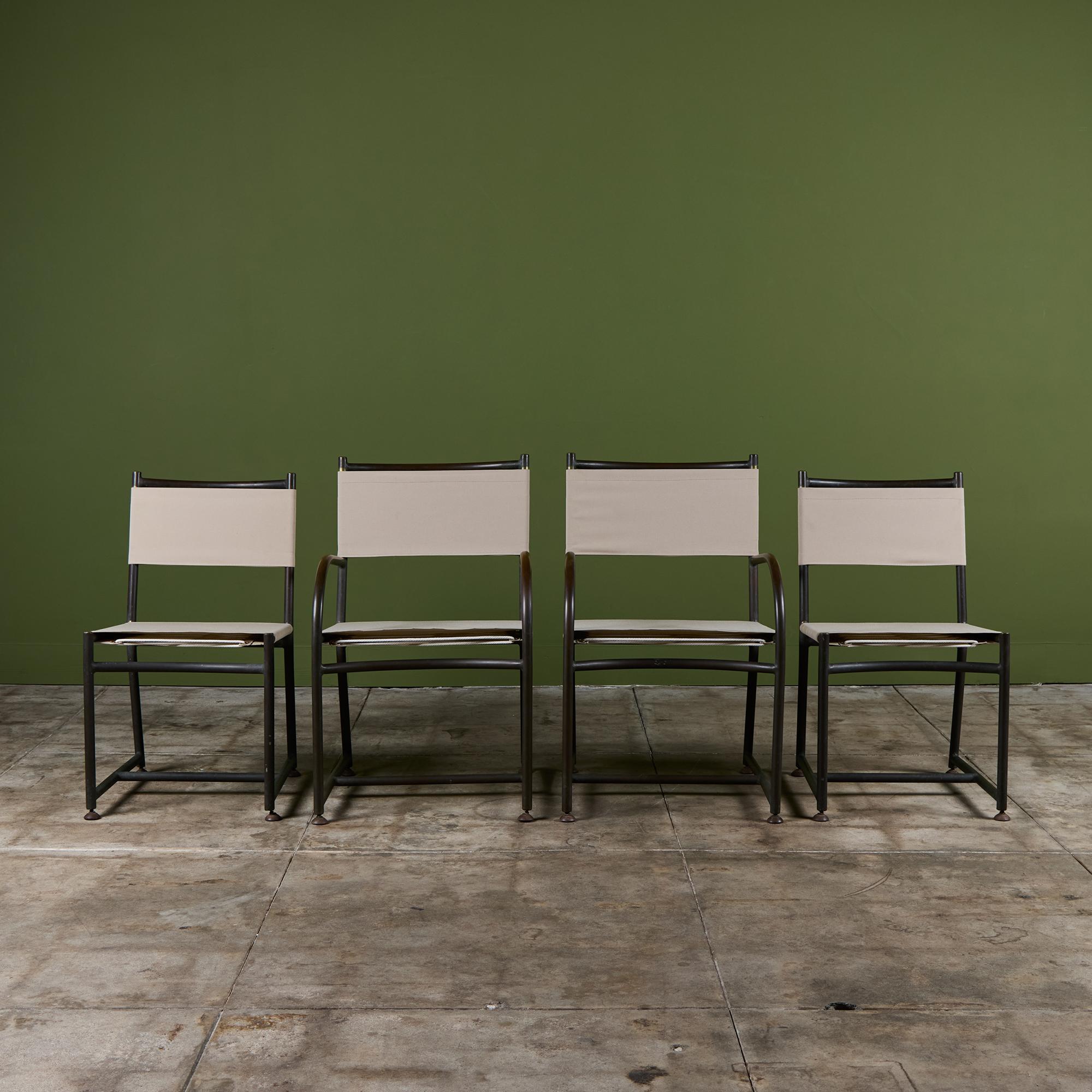 Set of four early dining chairs by Walter Lamb dating from the late 40s or early 50s, predating his work with Brown Jordan. The set consists of two armchairs and two side chairs that have a thick tubular bronze frame. Each chair has a canvas seat