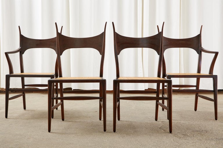 Iconic and rare set of four horned antler chairs designed by Edward Wormley for Dunbar. Known as 5580 model dining chairs crafted from mahogany with a caned seat. Arguably these are the most beautiful chair designs he ever created and one of the