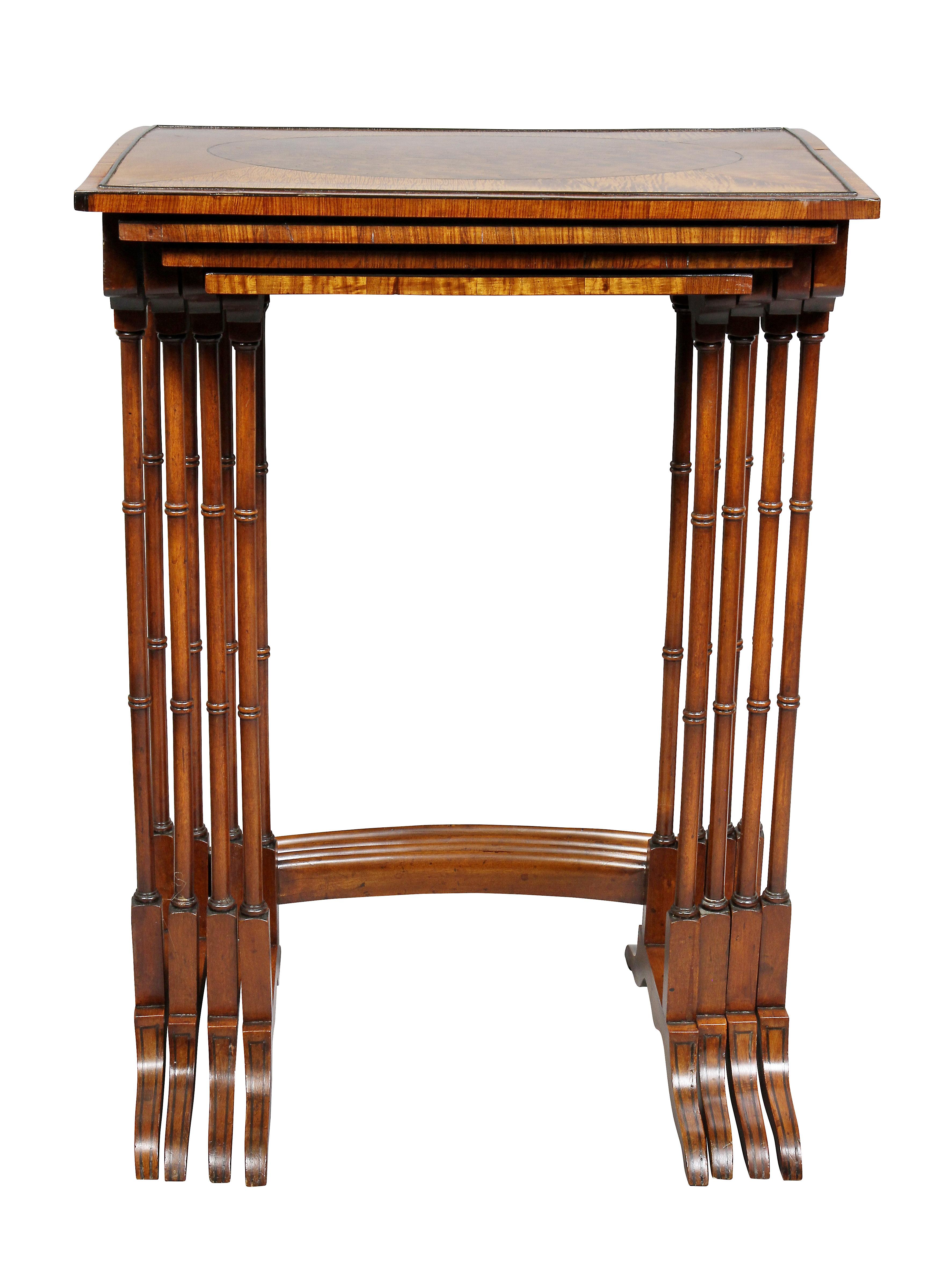 Each graduated table with a rectangular top with oval panel and satinwood border, bamboo turned legs, saber legs.
