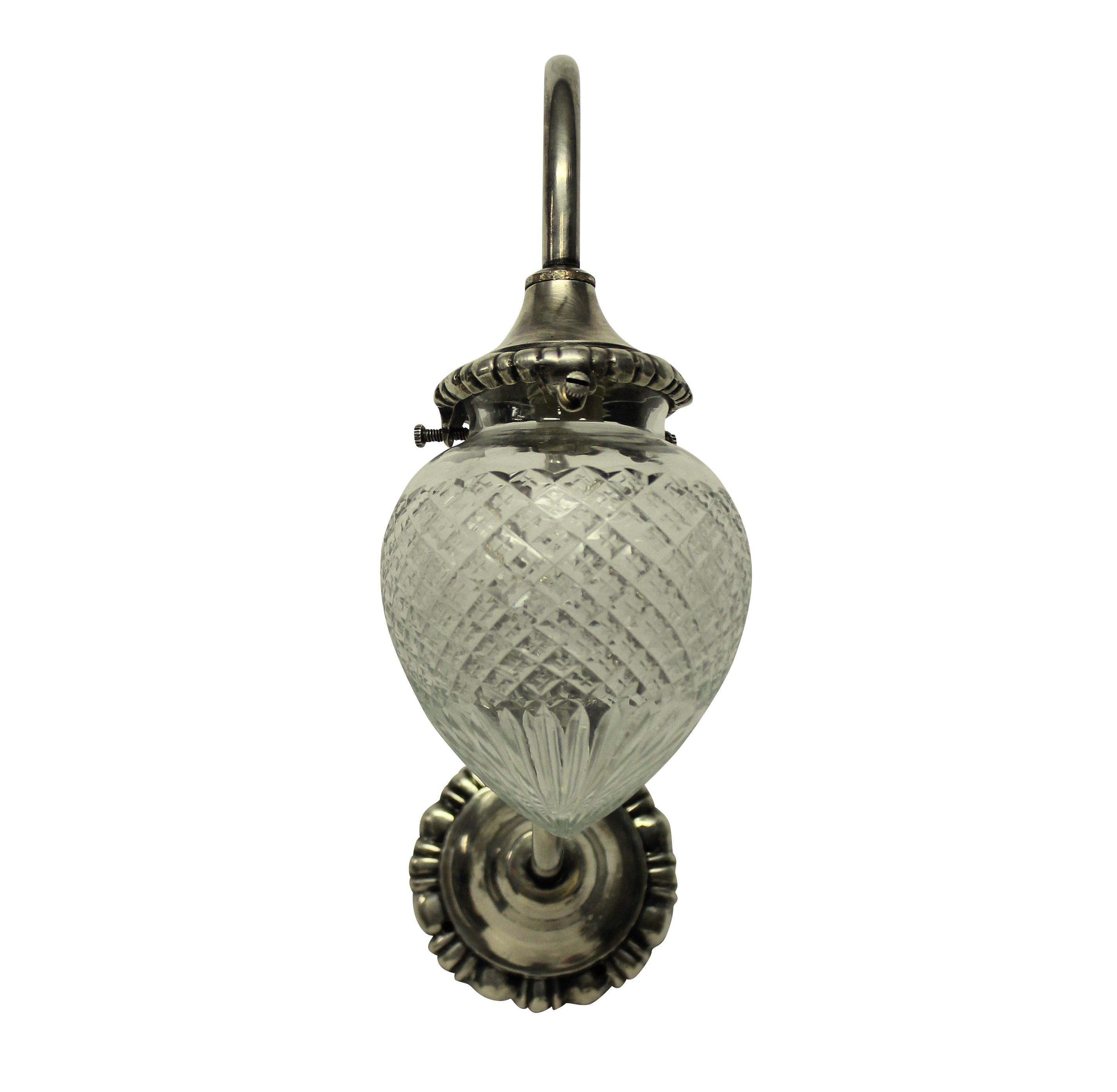 A set of four English Edwardian silver plated swan neck wall lights with acorn glass shades.