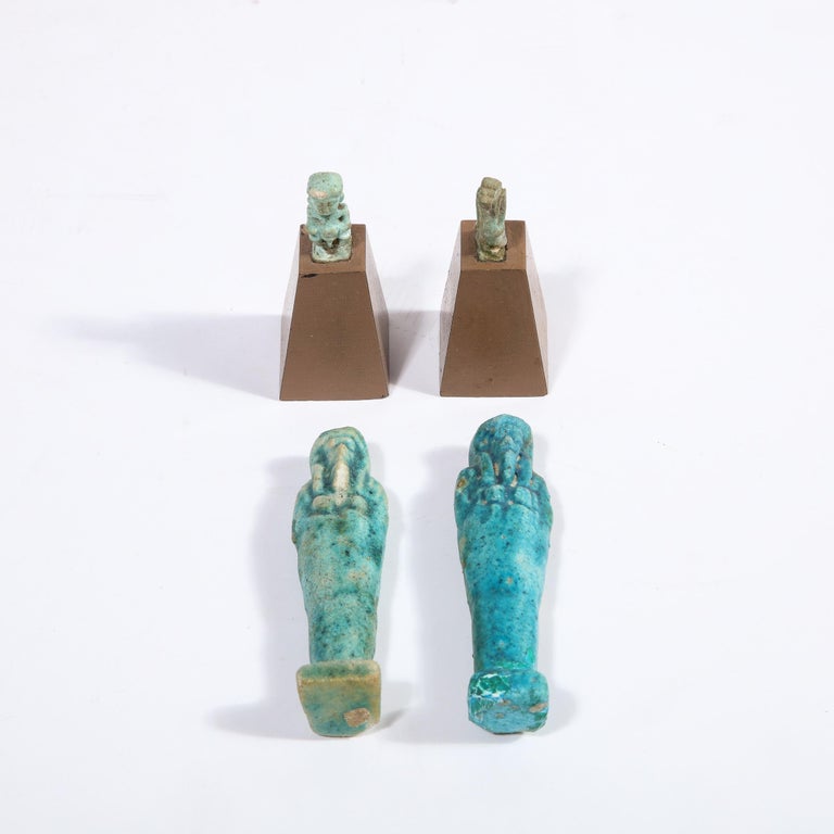 This captivating authentic Egyptian Faience set was realized in ancient Egypt circa 3100 BCE. It offers two sarcophagus figurines- suggestive of miniature versions of King Tut's tomb- hand finished in a beautiful turquoise hue (a glaze created by