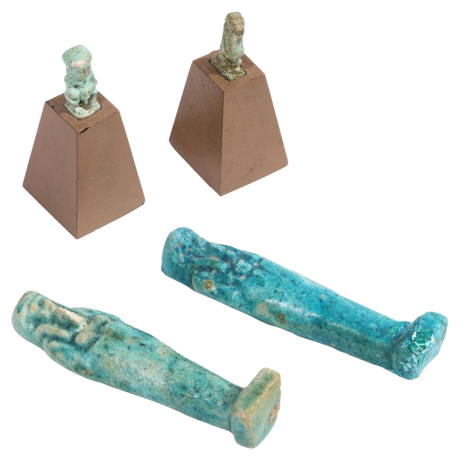 Ensemble de quatre antiquités égyptiennes, paire de sarcophages en faïence et deux figurines en vente
