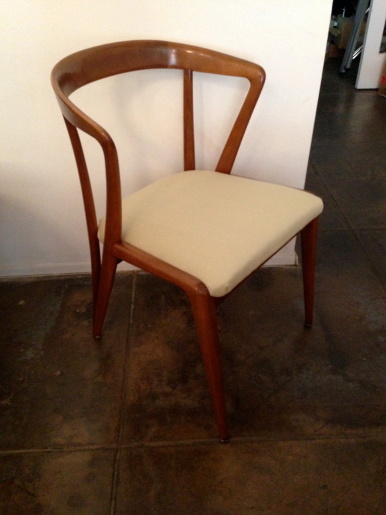 A set of sculptural light/medium walnut chairs by Bertha Schaefer for Singer and Son. Reupholstered in a golden cream/off white cotton/linen blend. Original Tag. Chairs were made in Italy for Singer and son. Listed price is for 4. Table not