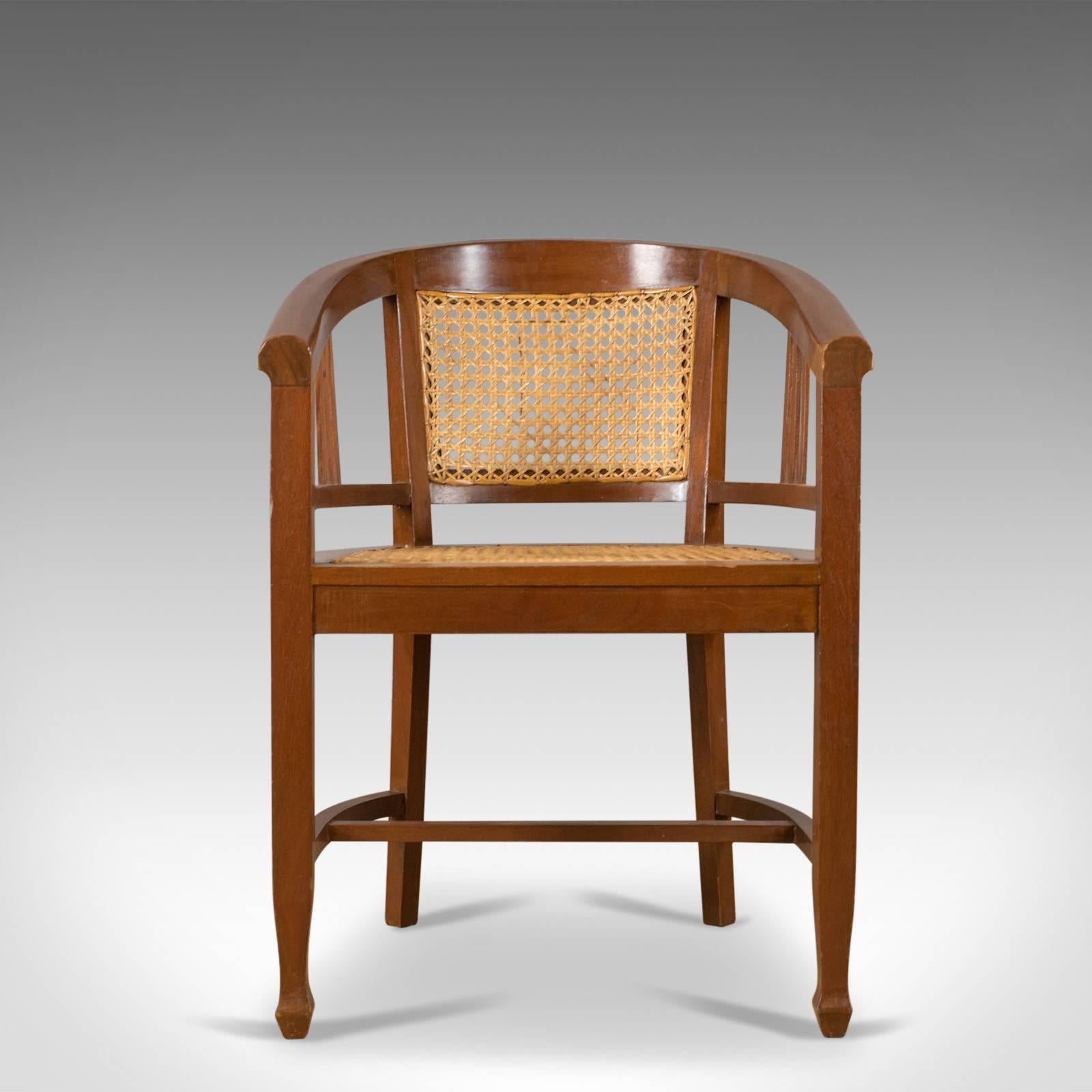 This is a set of four elbow chairs, 20th century, contemporary tub dining chairs in a cane bergère style displaying oriental influence.

Solid mahogany frames in good order throughout
The chairs display well in rich, coffee tones
Of quality