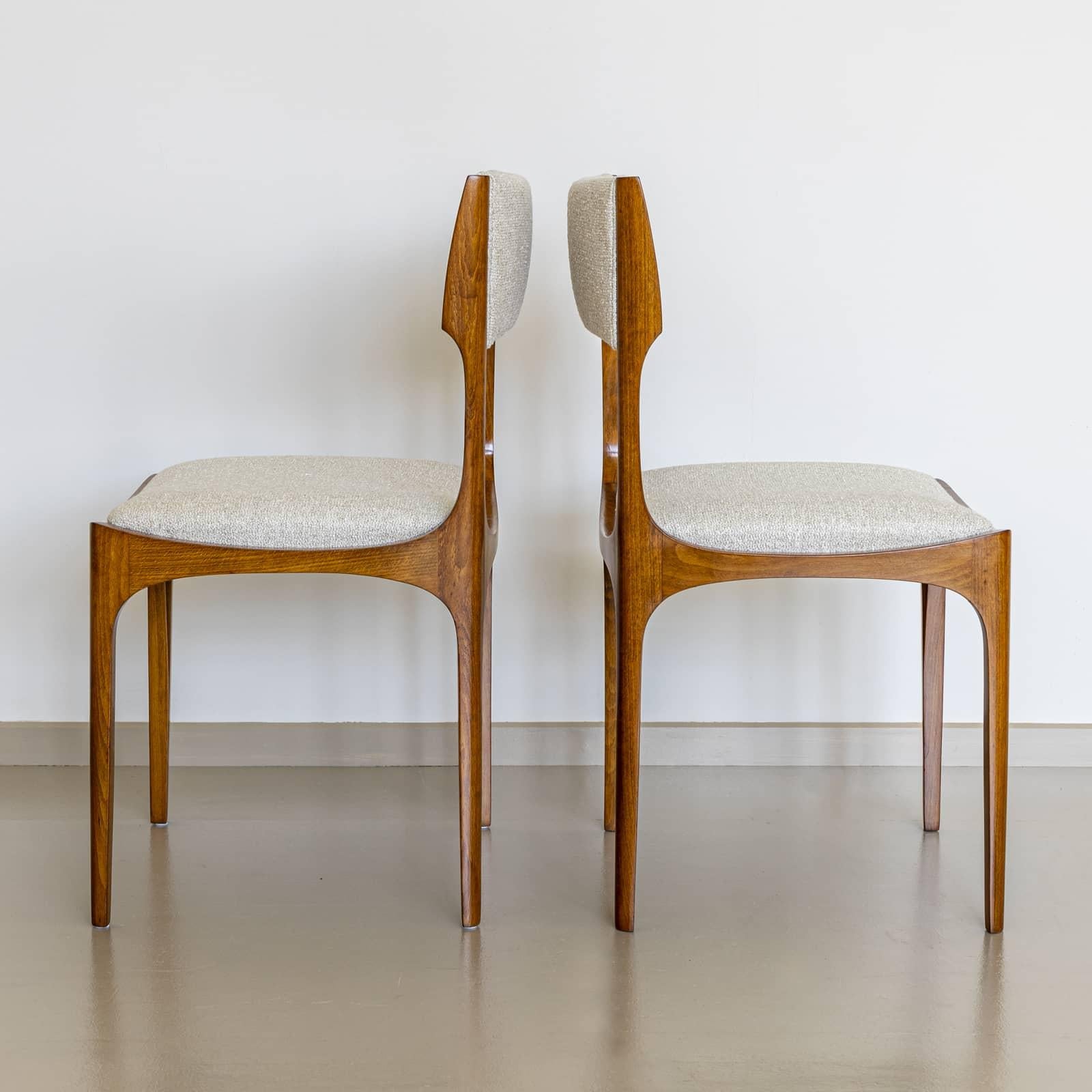Set of four Elisabetta side chairs designed by Giuseppe Gibelli for Sormani in 1963. The chairs are made of solid ash wood and feature straight legs and gently convex-concave shaped frames. Small wedges protrude from the sides of the backrest and