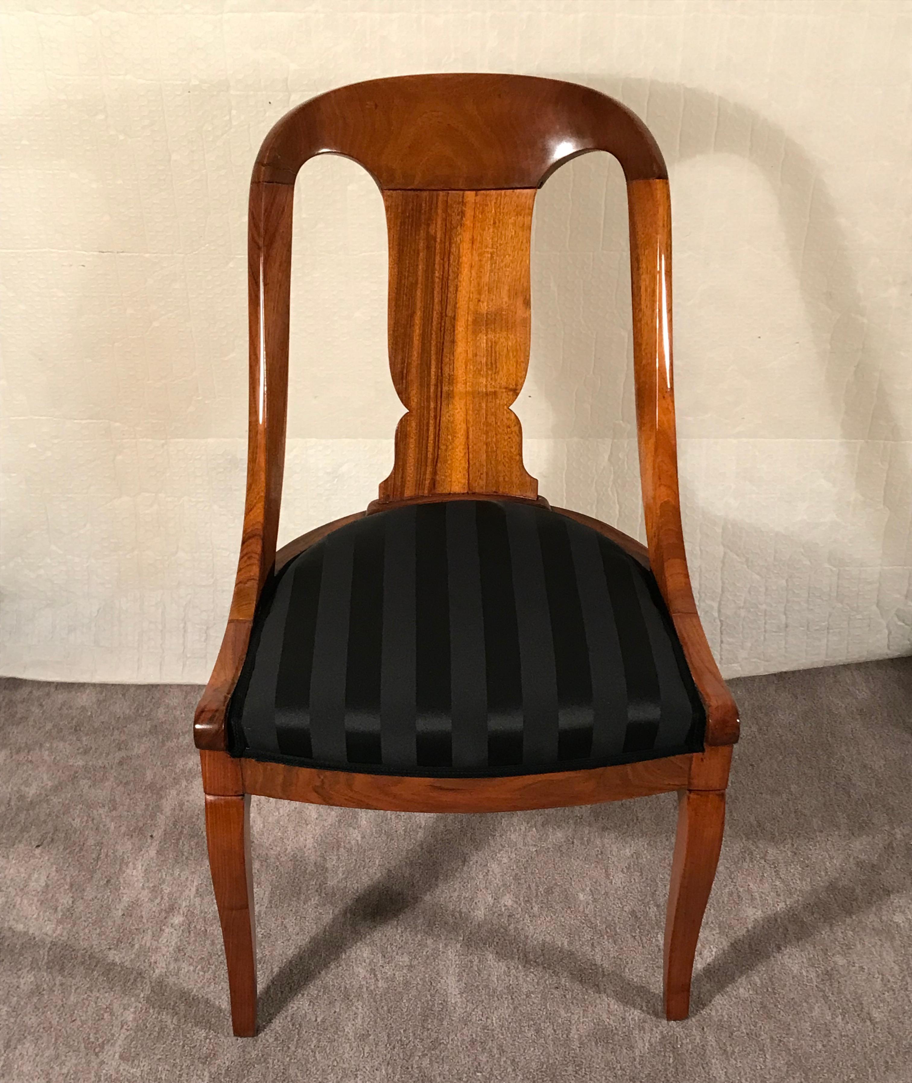 This set of 4 Empire Barrel chairs dates back to around 1810-20. They come from France. The chairs have a very pretty walnut veneer. They have a very elegant design with an open work back. The chairs are in very good refinished condition. They have