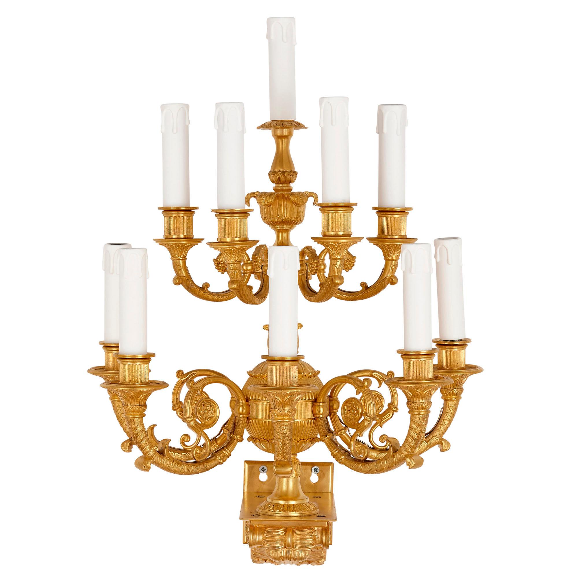 Set of four Empire style ten-branch gilt bronze sconces
French, circa 1890
Measures: Height 56cm, width 40cm, depth 32cm

Each of the sconces in this set of four is crafted from gilt bronze in an ornate French Empire style. Each scone features