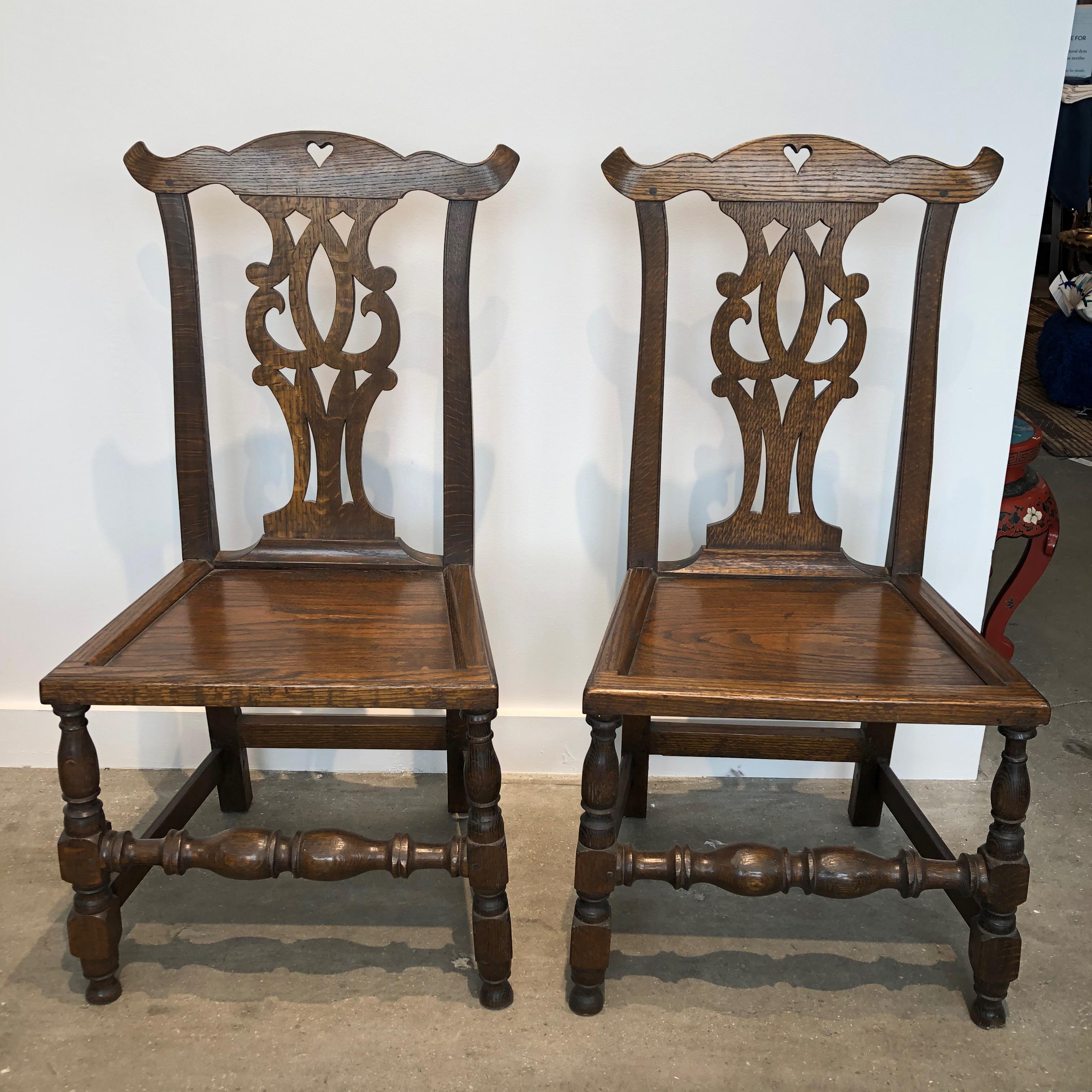 Set of four English bench-made Chippendale plank seat elm chairs, circa 1900.