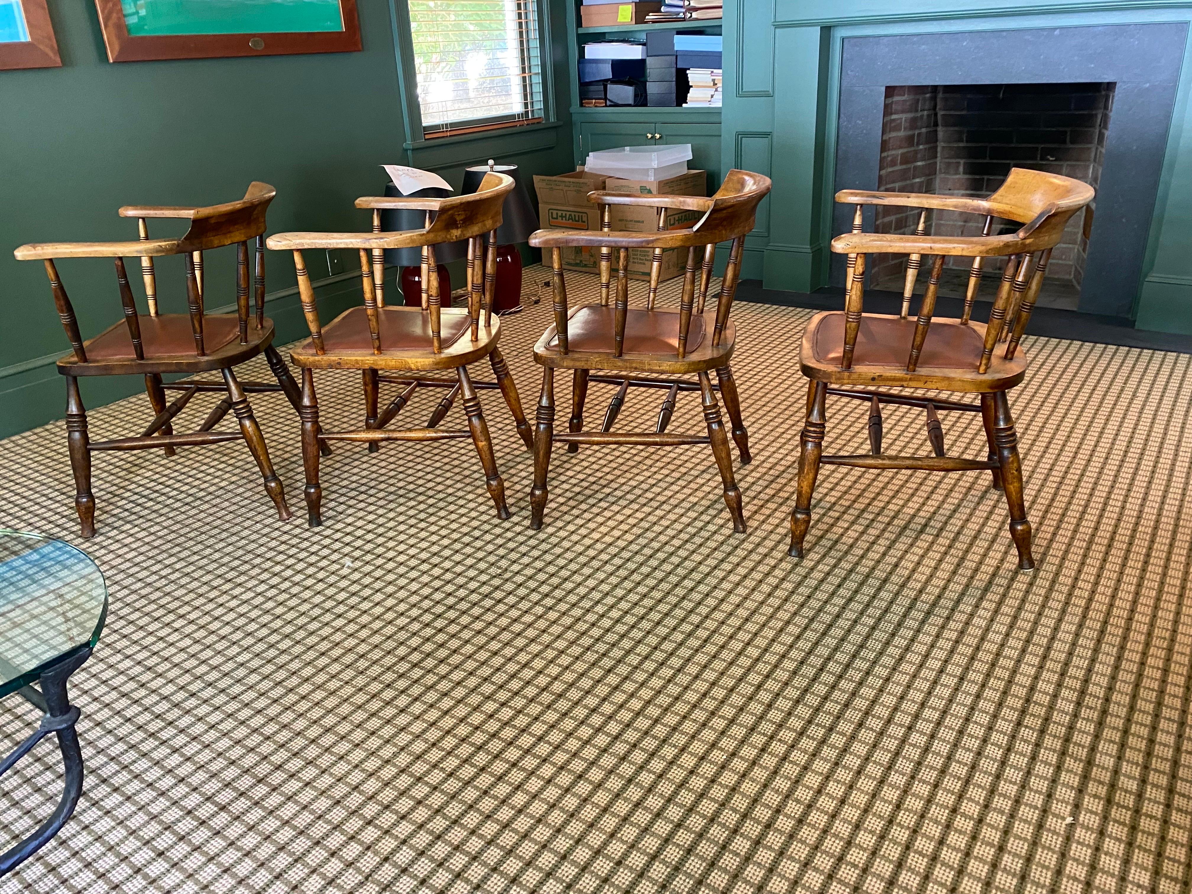 Set of four English birch tavern chairs.
Lovely worn rounded seat back chairs with beautifully turned spindles and legs, and a fantastic patina only time can bestow with a burgundy red leather seat. 

Measures: 24