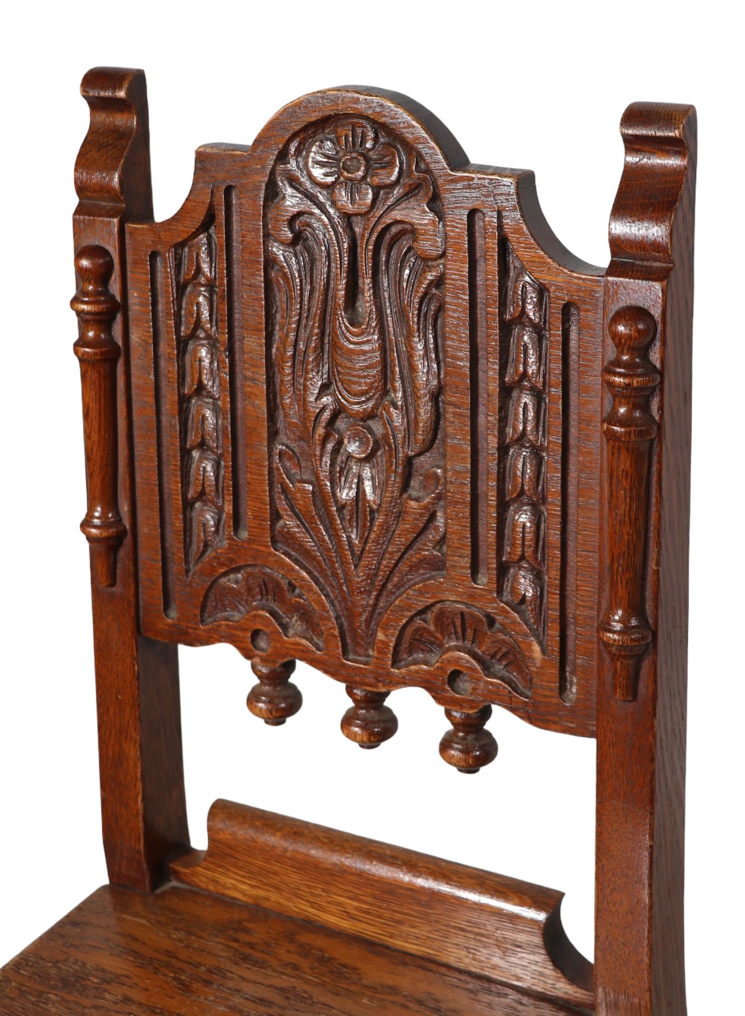 British Set of Four English Carved Oak Cafe Dining Chairs in the Jacobean Style c 1920's For Sale
