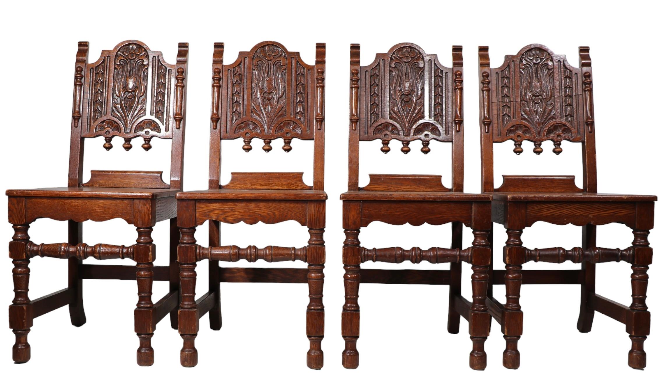 Set of Four English Carved Oak Cafe Dining Chairs in the Jacobean Style c 1920's In Good Condition For Sale In New York, NY