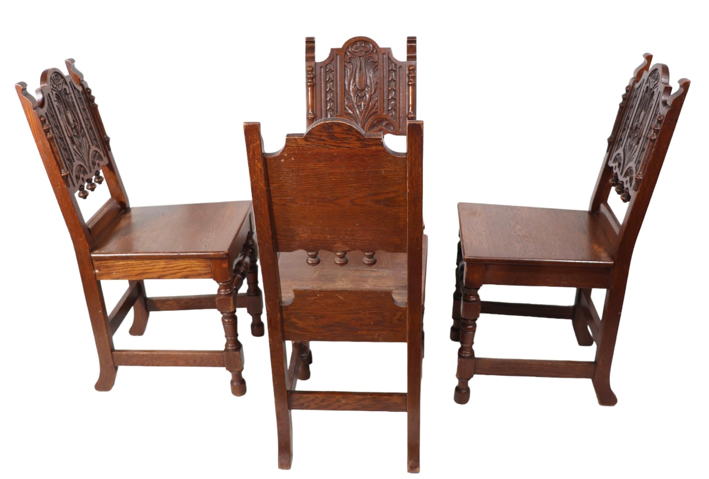 20th Century Set of Four English Carved Oak Cafe Dining Chairs in the Jacobean Style c 1920's For Sale