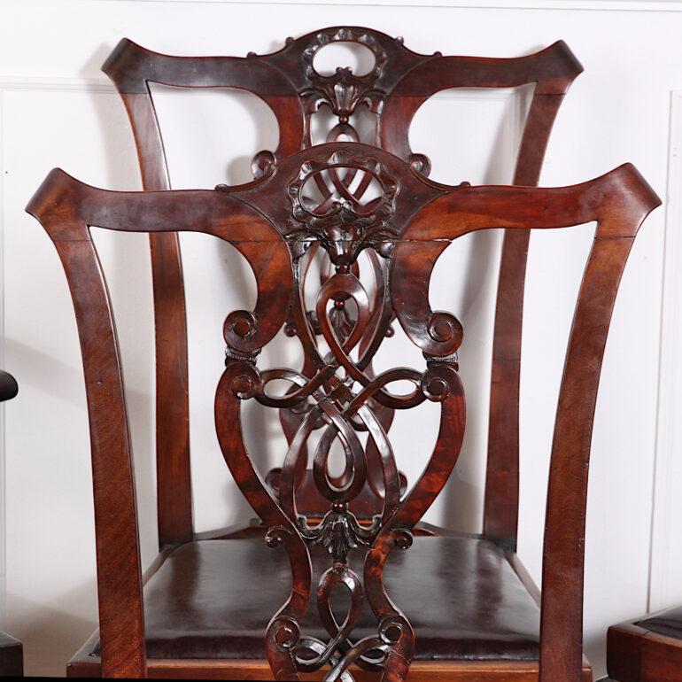 Set of four English Chippendale-revival dining chairs with highly-detailed pierce-carved back splats and boldly carved cabriole legs with ball-and-claw feet. C. 1910 Three side chairs and a single armchair.
Dimensions:
Armchair 25 inches wide by
