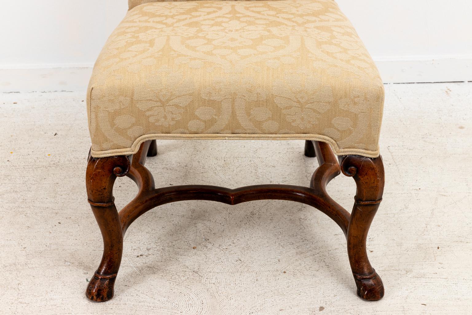 Circa 1980s set of four English Queen Anne style side chairs upholstered in a Rogers & Goffington Linen Damask fabric with carved legs shaped like horse hooves and bottom H-shaped cross stretchers. Made in the United States. Please note of wear