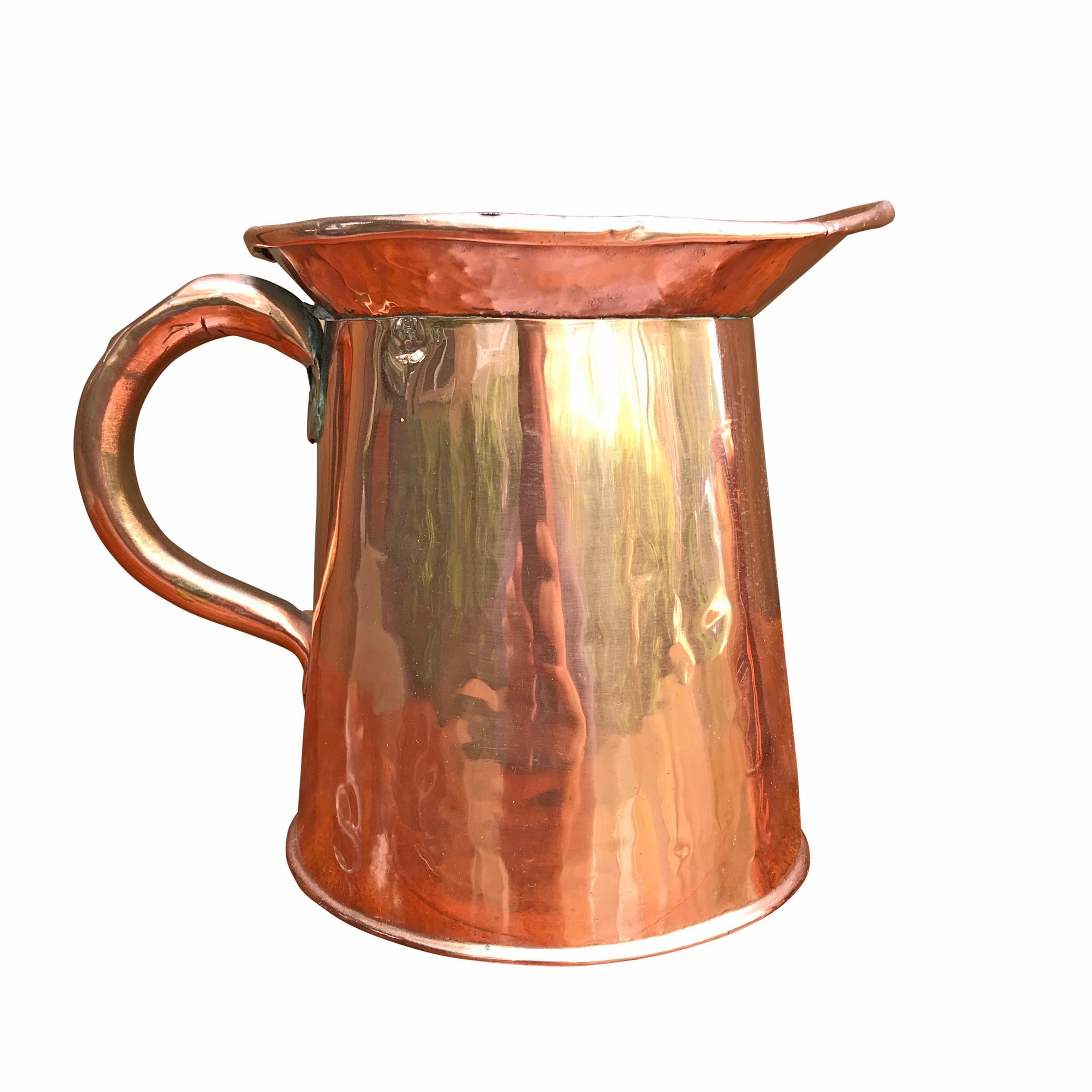 A set of four English Victorian period copper graduated pitchers, the largest being engraved 