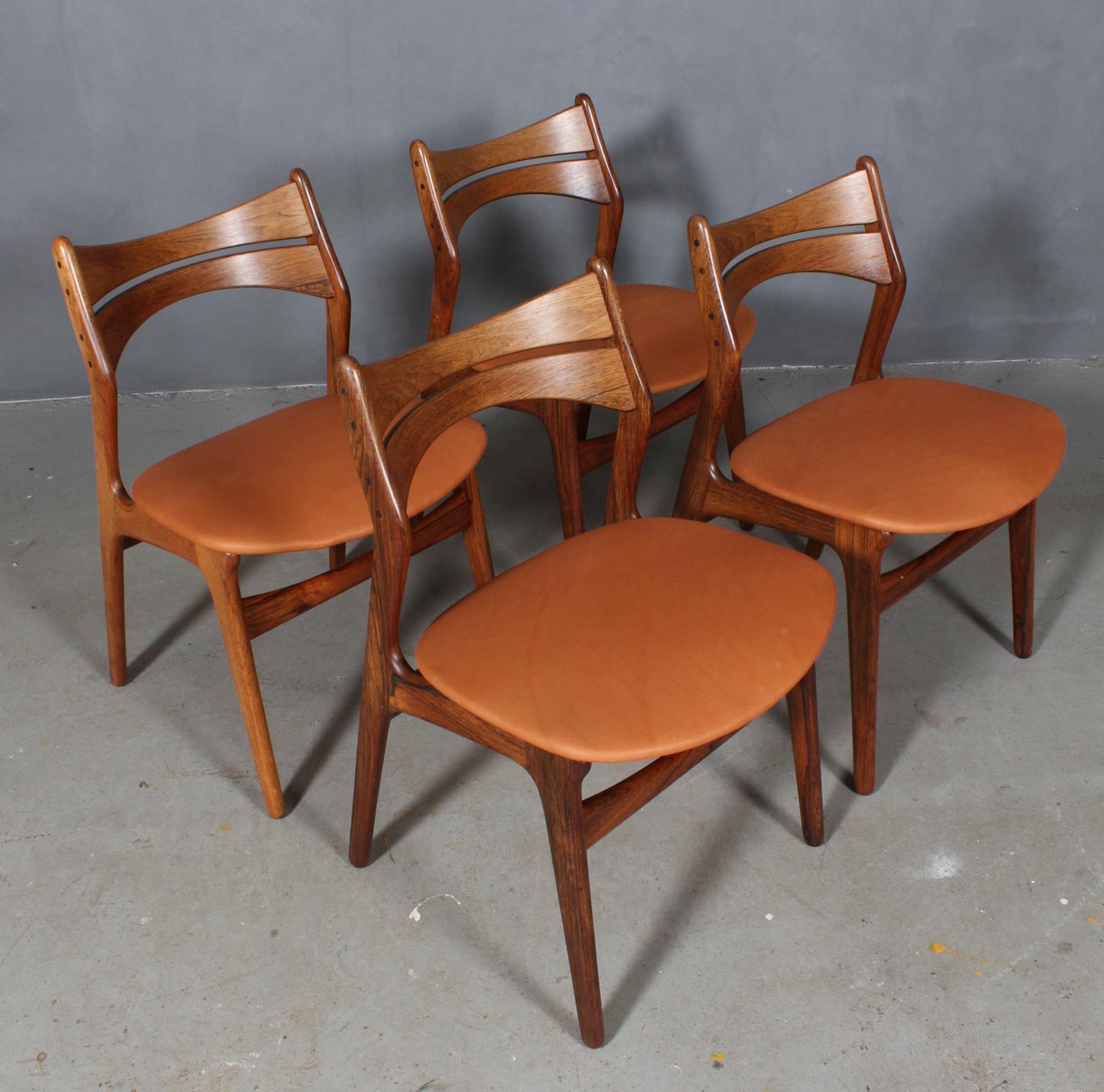 Four Eric Buch chairs with frame of partly solid rosewood.

New upholstered with tan aniline leather. 

Model 310, made by Chr Christensens Møbelfabrik, Denmark.