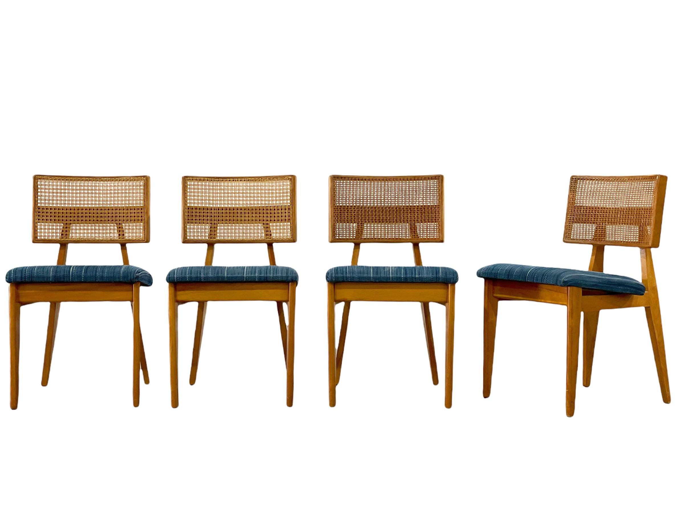 Rare set of four Mid-Century Modern dining chairs by Ernest Farmer for George Nelson Associates and produced by Herman Miller. Solid maple frames with cane backs and upholstered seats. Cane is intact on all four backs. Frames have been thoroughly