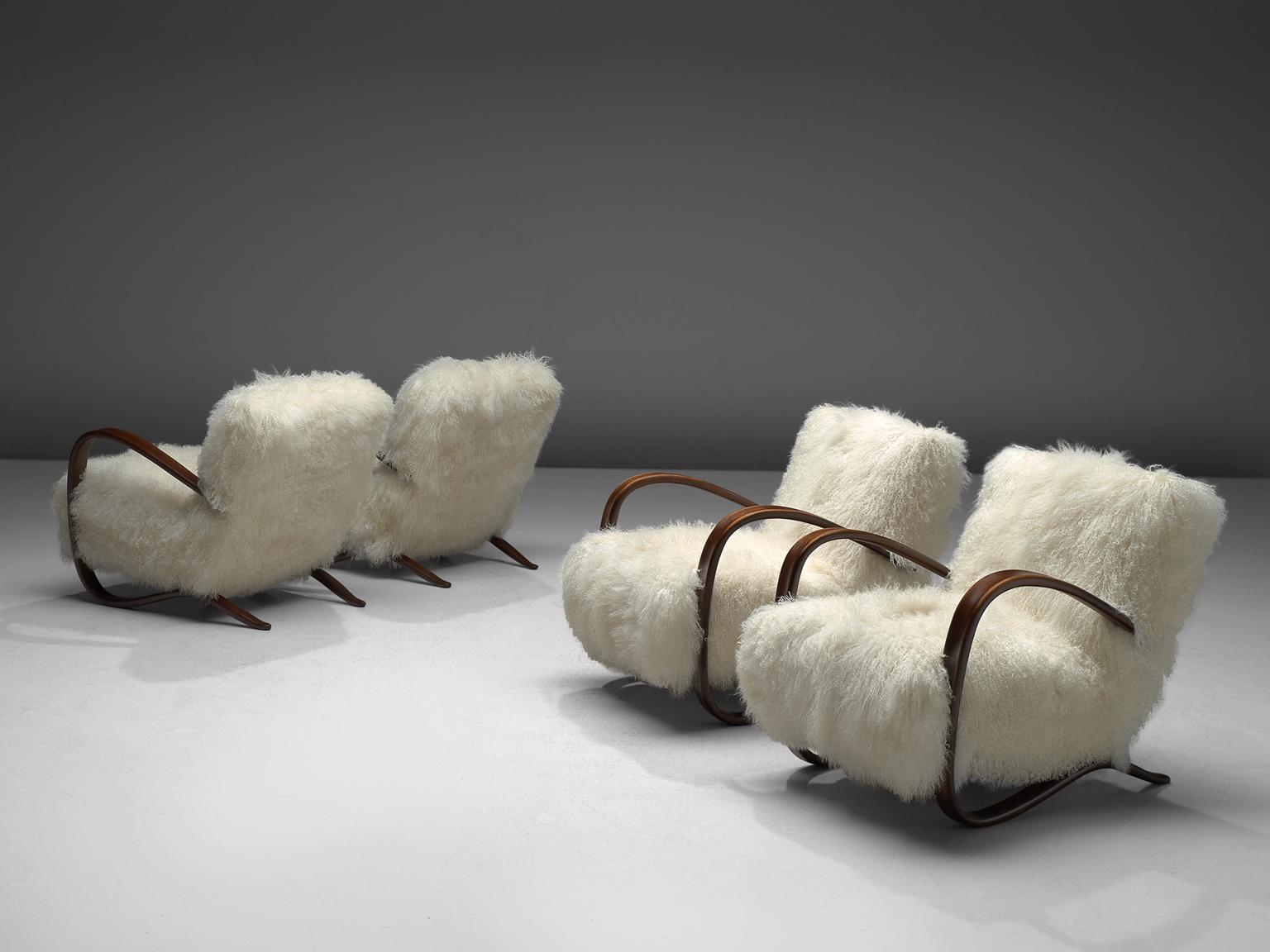 Jindrich Halabala (1903-1978), set of lounge chairs, in stained beech and sheepskin, Czech Republic, 1930s. 

Extra ordinary set of white easy chairs with Tibetan lambswool upholstery. These chairs have a very dynamic and abundant appearance. This