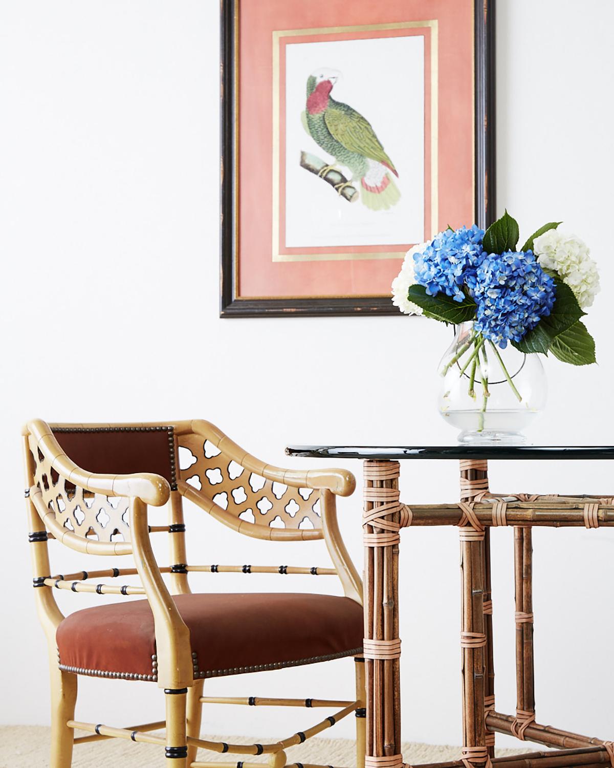 Rare and unusual set of four lounge chairs or armchairs made by Trouvailles furniture. Featuring a lacquered faux-bamboo carved frame decorated with quatrefoil designs on the barrel back form. Accented with black highlights on the legs and numerous