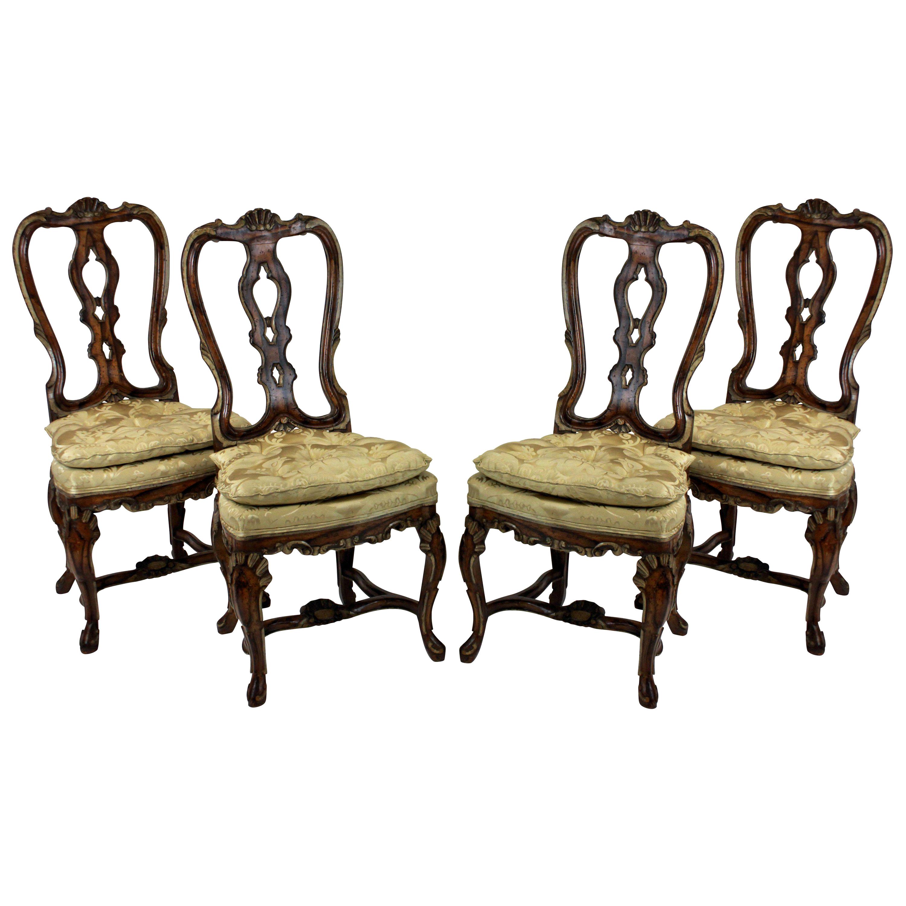 A set of four fine high back George II dining chairs in faux walnut with painted detail. Beautifully carved with silk damask seats.
  