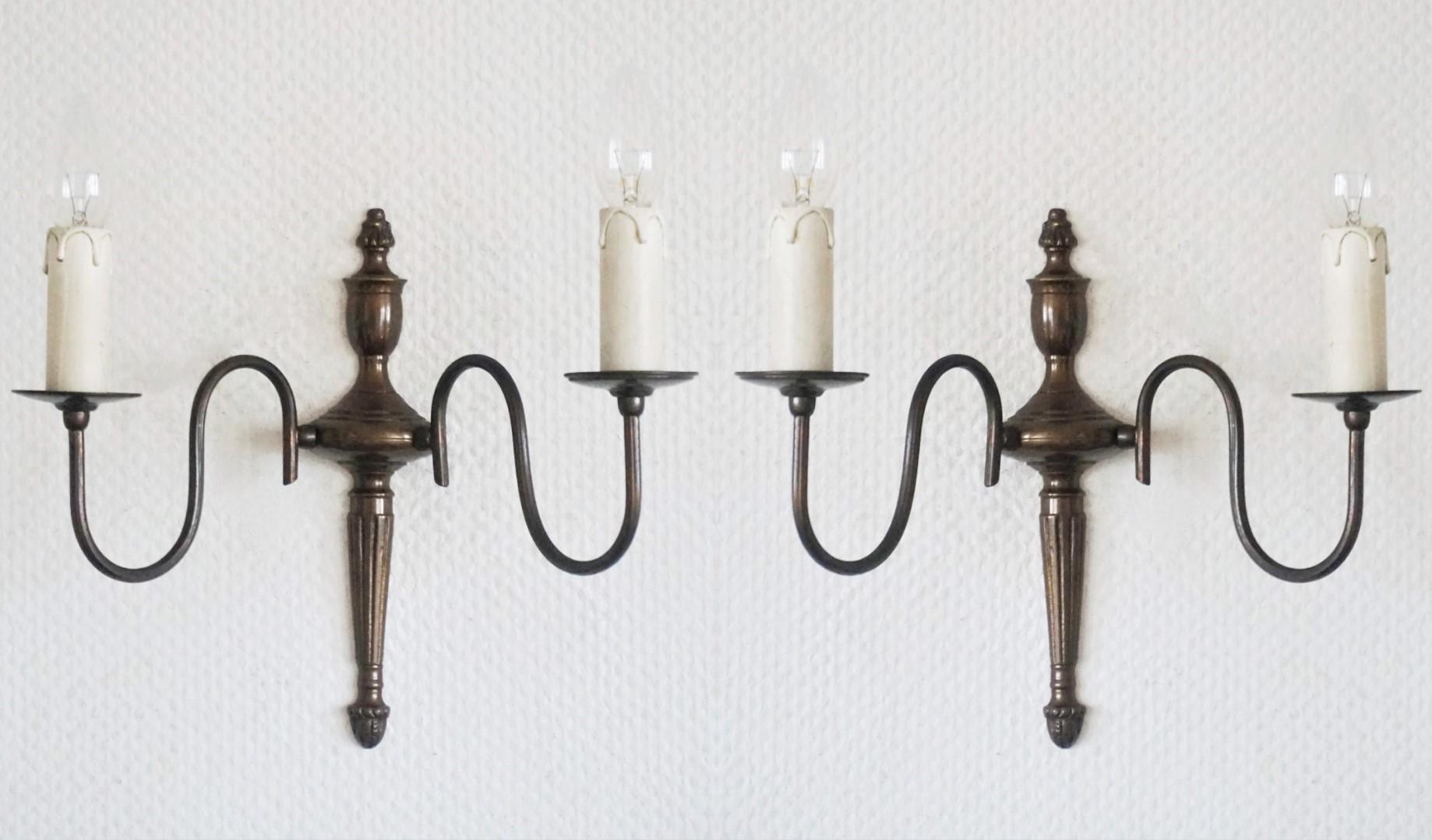Set of four cast brass two-light wall sconces in Flemish style with two arms in double volute.
All four sconces are in very good condition, hand polished and rewired.
Number of lights: Two E14 candelabras bulb sockets each sconce.
Measures without