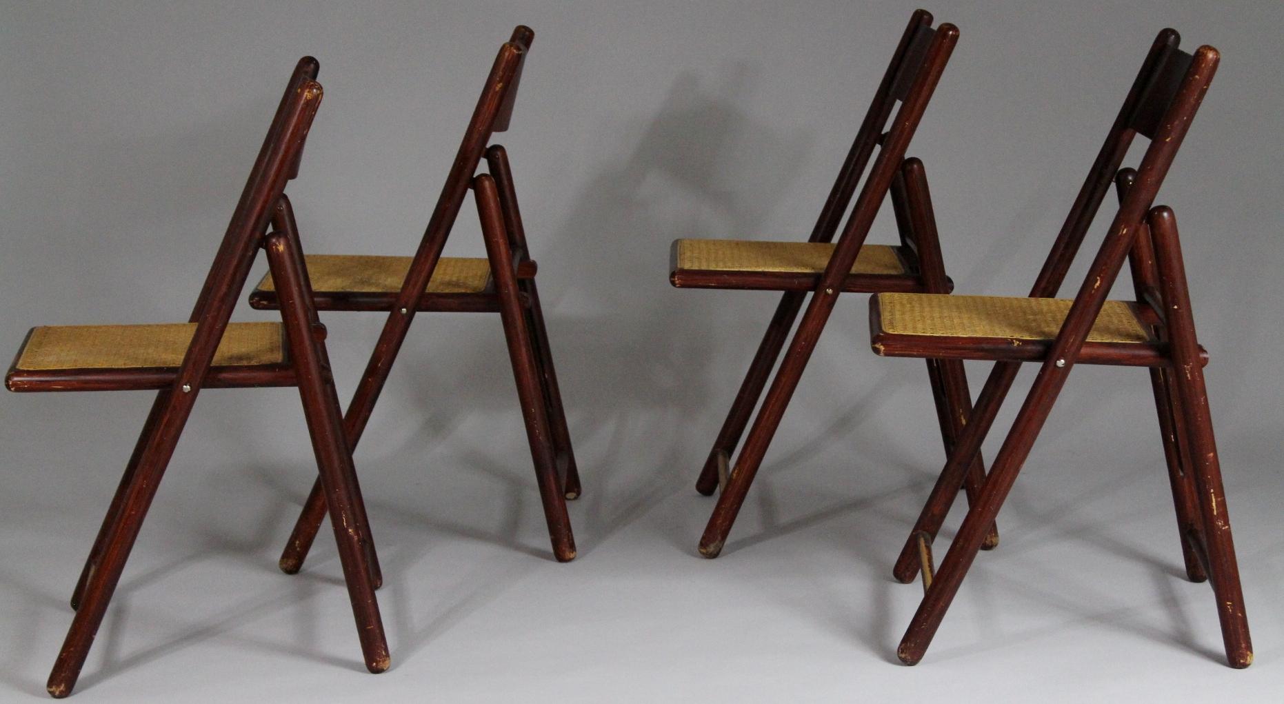Set of four folding chairs from the 1970s. Material is grained finished beech and cane.