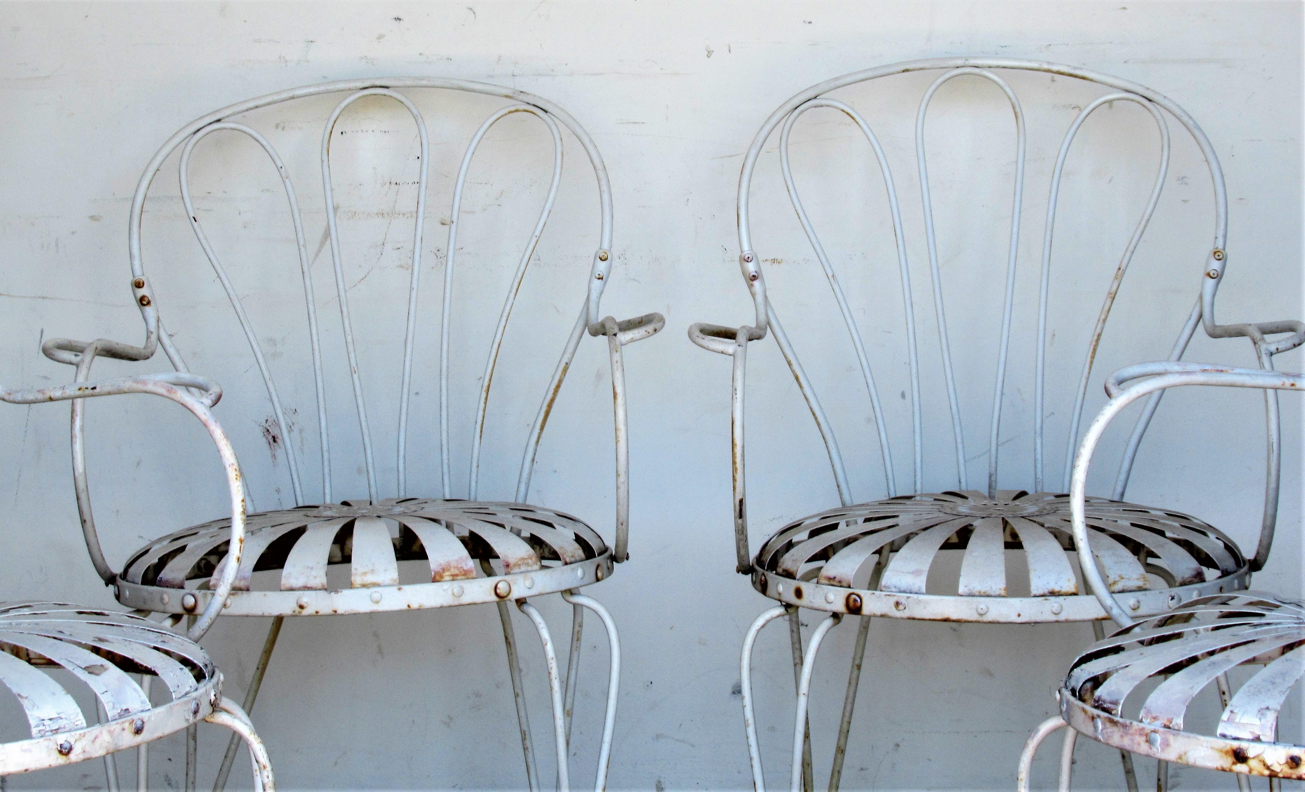 Set of four Francois Carre iron garden chairs with sunburst / pinwheel design spring steel seats. All four chairs in overall old worn white painted surface, circa 1930-1940. Look at all pictures and read condition report in comment section/