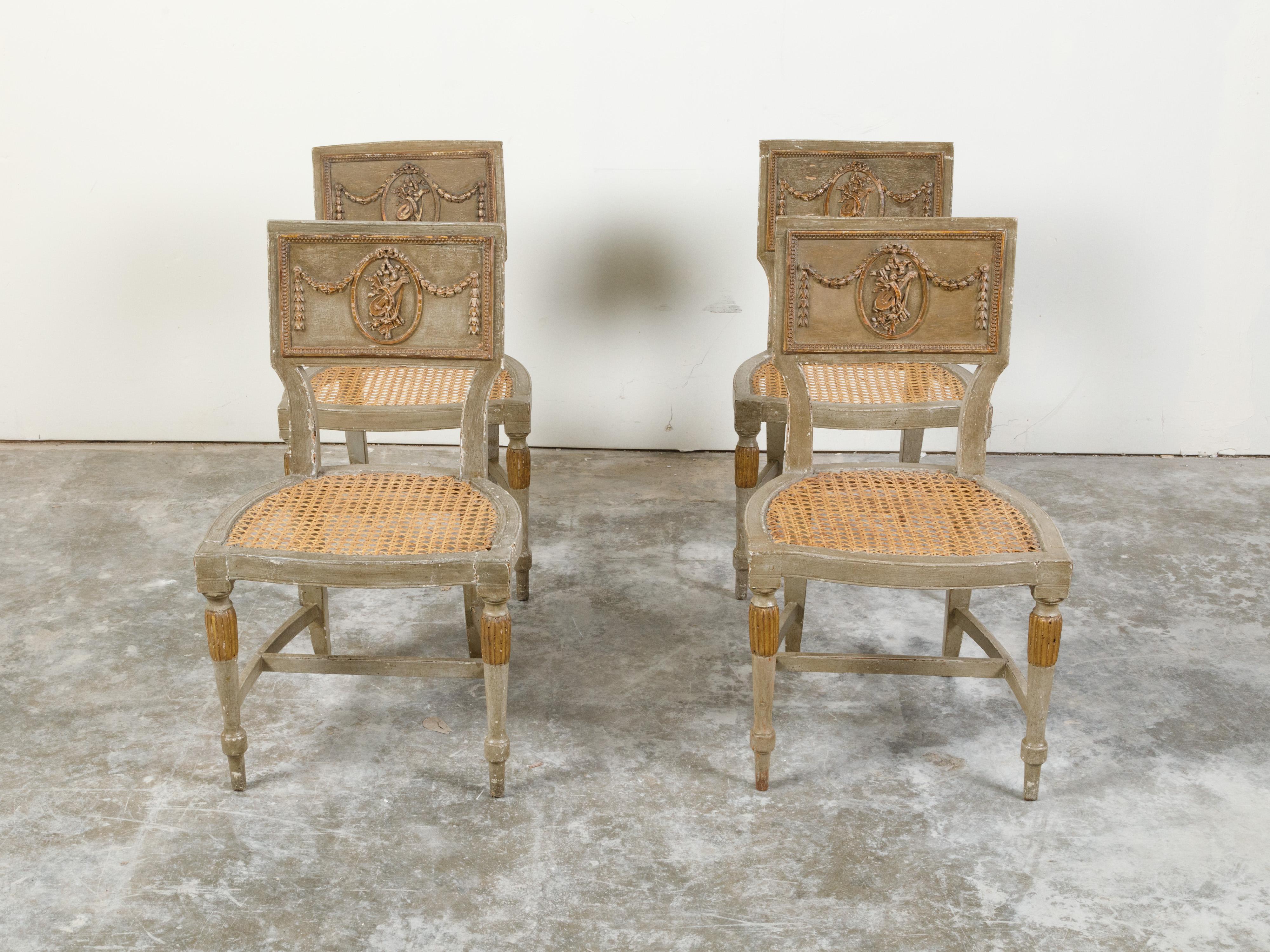 A set of four French painted wood side chairs from the 18th century, with carved Liberal Arts allegory. Created in France during the 18th century, each of this set of four side chairs features a rectangular slightly curved back adorned with beads