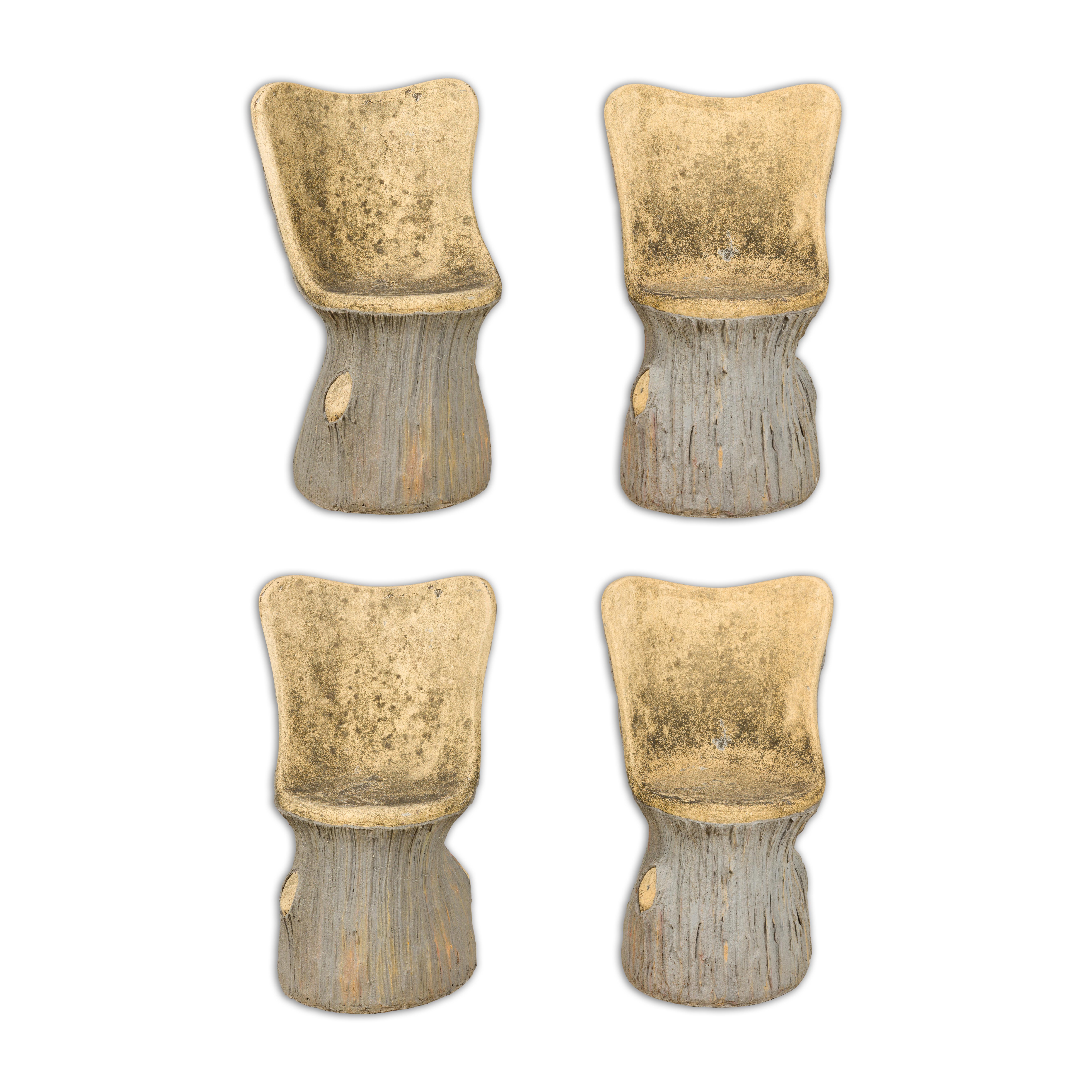 A set of four French faux bois garden chairs circa 1930 with weathered appearance. Transform your outdoor space with this charming set of four French faux bois garden chairs from the 1930s. Crafted with exceptional artistry, these weathered chairs