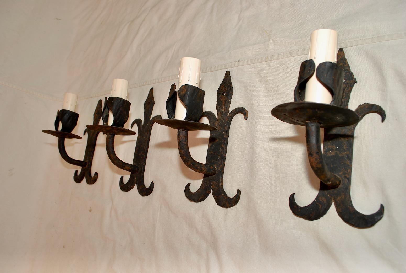 We also have our own line of wrought iron reproduction sconces and chandeliers, or we could do your own design
A very nice set of four all hands made wrought iron sconces, the patina is much nicer in person, we could sell them by pair if you