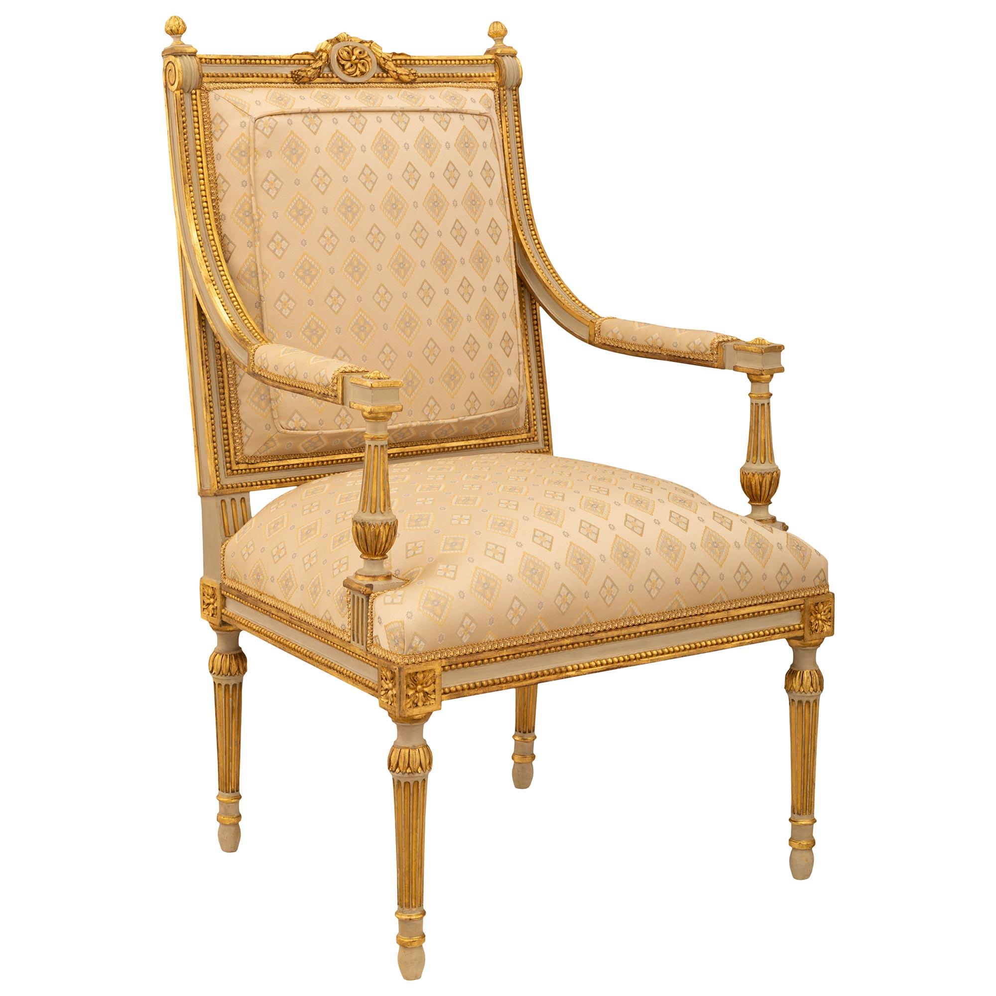 A sensational set of four French 19th century Louis XVI st. Napoleon III Period patinated and Giltwood armchairs. The set are raised by elegant circular fluted tapered legs ending with ball feet while at the top is a Giltwood band of palmettes.