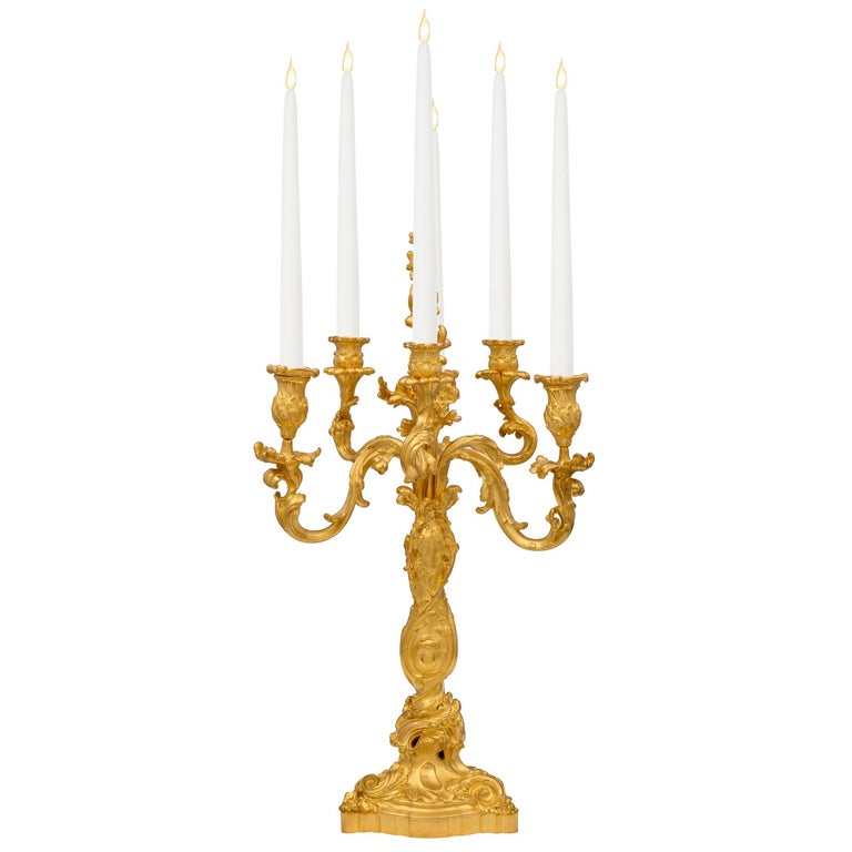 A superb and most impressive set of four French 19th century Louis XV st. ormolu candelabras, signed by Robert Frères. Each candelabra is raised by an elegant scalloped shape base with exceptional Rocaille and scrolled foliate designs and lovely