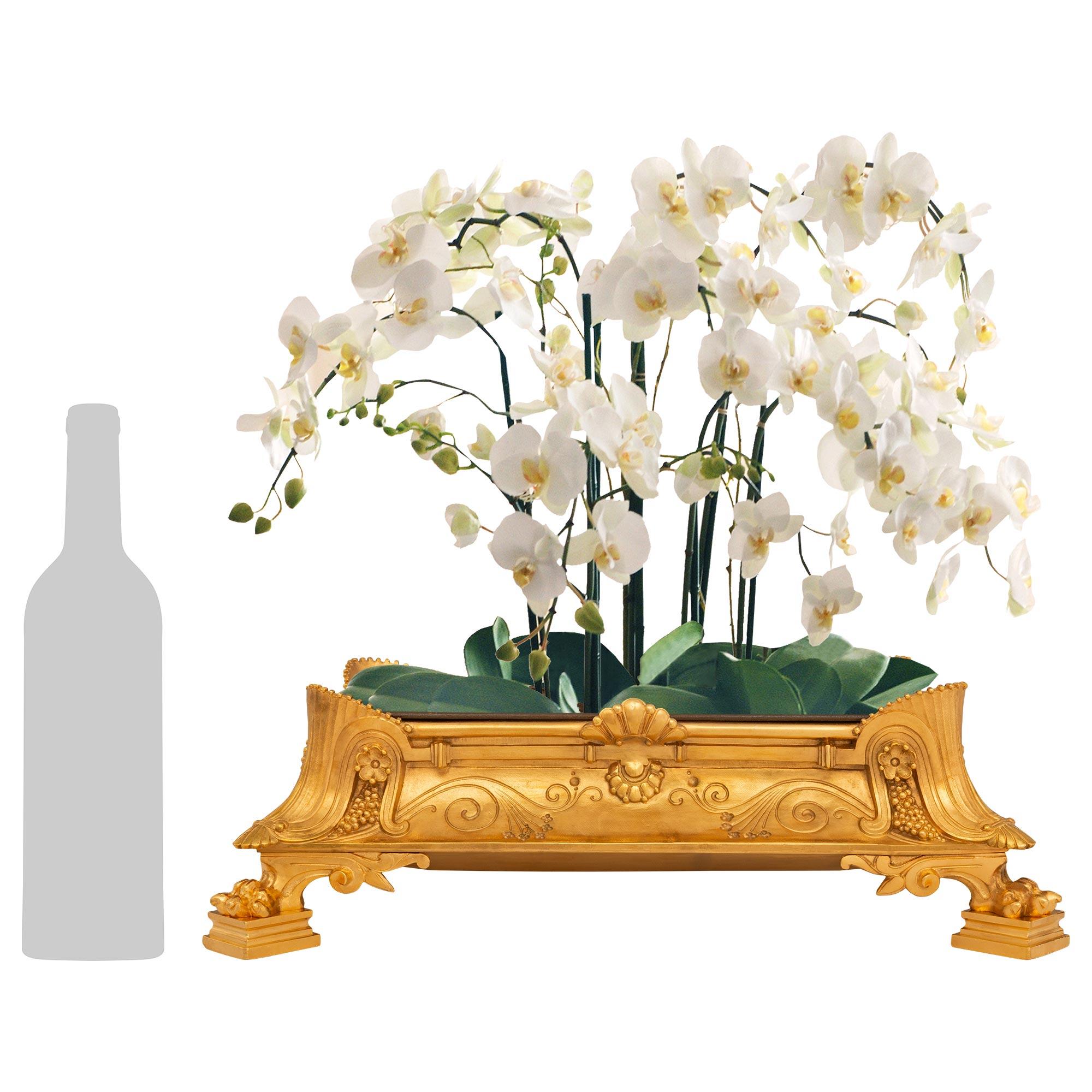 A striking and most unique set of four French 19th century Renaissance st. Ormolu centerpiece/planters. Each centerpiece is raised by elegant mottled supports below handsome paw feet and remarkable scrolled foliate fluted elements at each corner