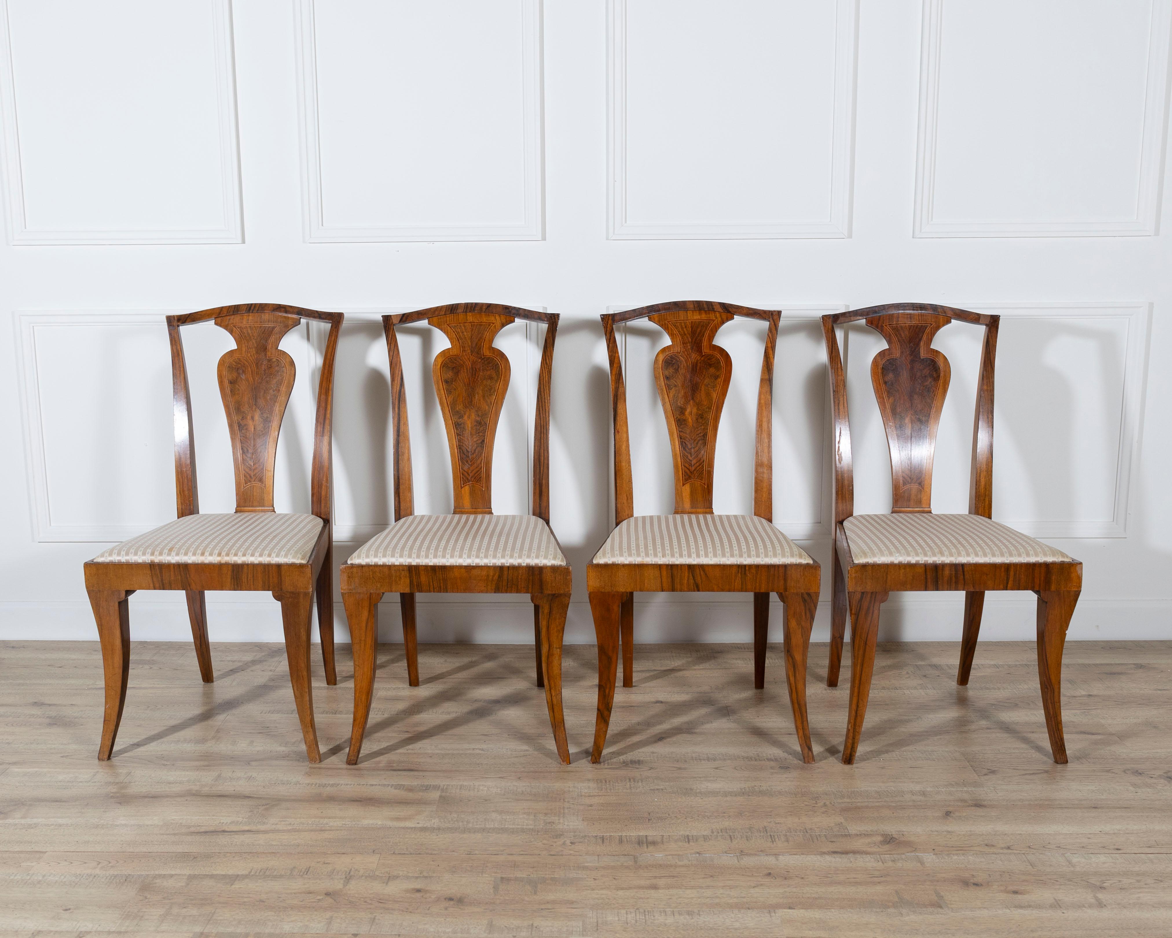 A striking set of four French Art Deco chairs from the 1920s–1930s, masterfully crafted in solid wood veneered with flamed walnut, highlighted by bois de rose and fine boxwood fillets. The design showcases the refined geometry and elegant restraint