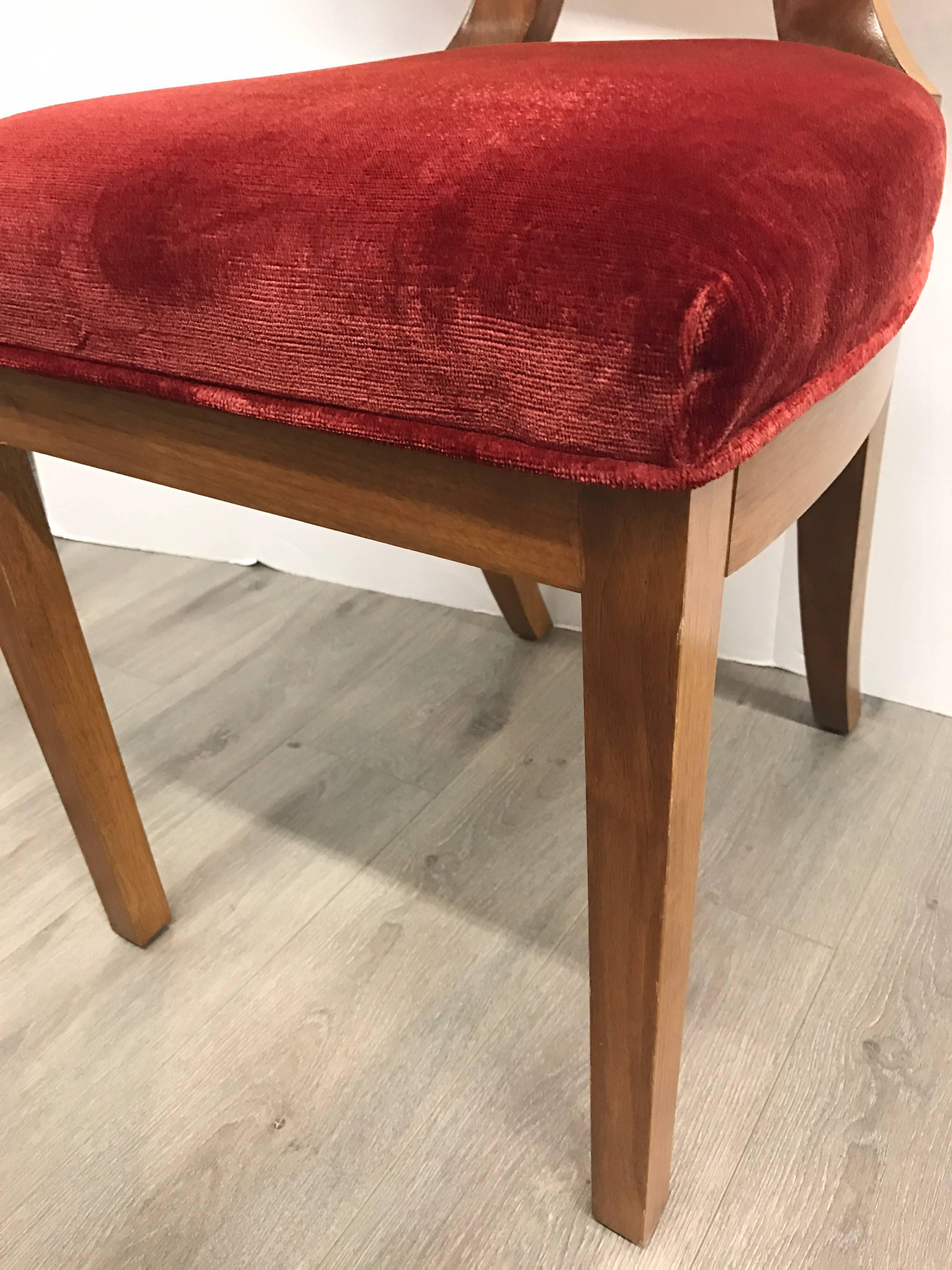 Magnificent set of four matching French Art Deco dining chair with circle medallions and upholstered in a luxurious deep red velvet.
