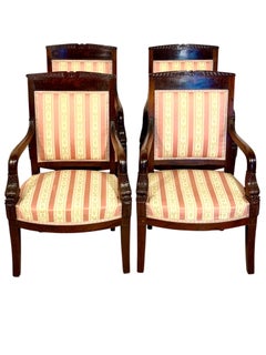 Set of Four French Empire Period Walnut Armchairs with Dolphin-Head