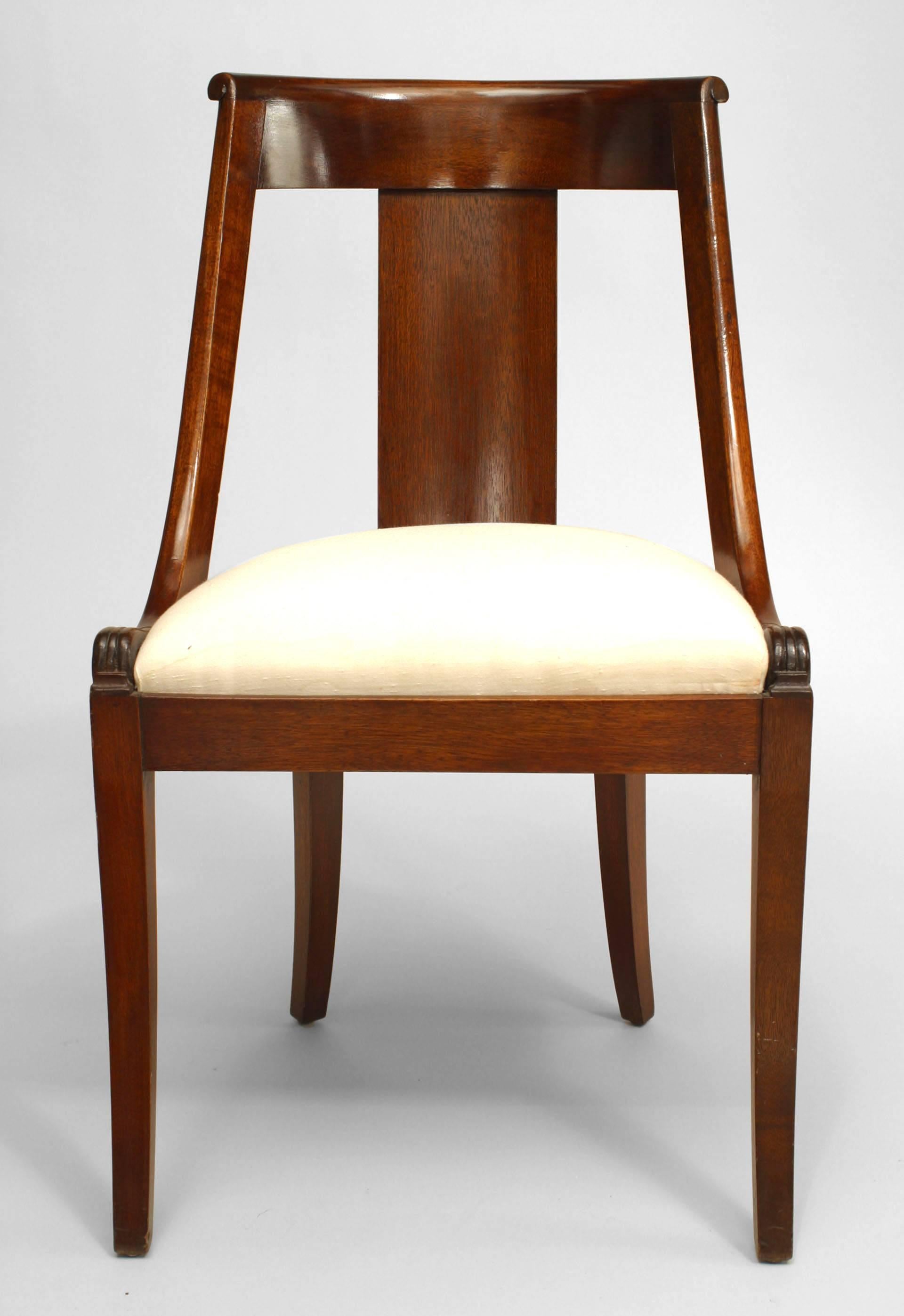 Set of four French Empire style (19th century) mahogany sleigh back side chairs with slip seat.
 