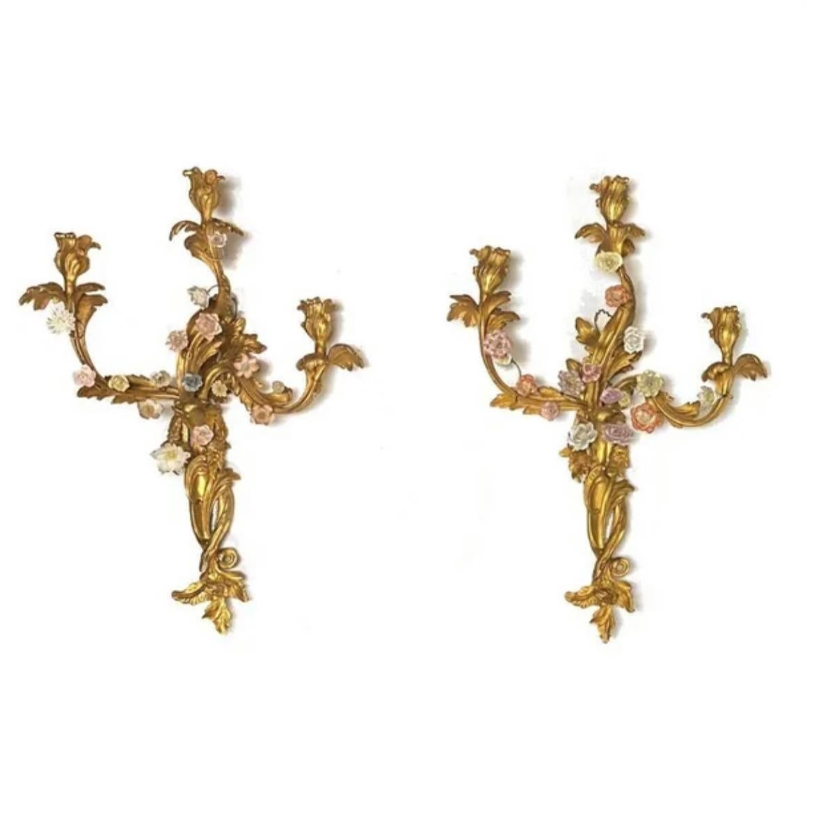 Set of four (4) French gilt bronze two-light wall appliques in the Rococo style with numerous multi-colored porcelain flower heads. May be electrified.