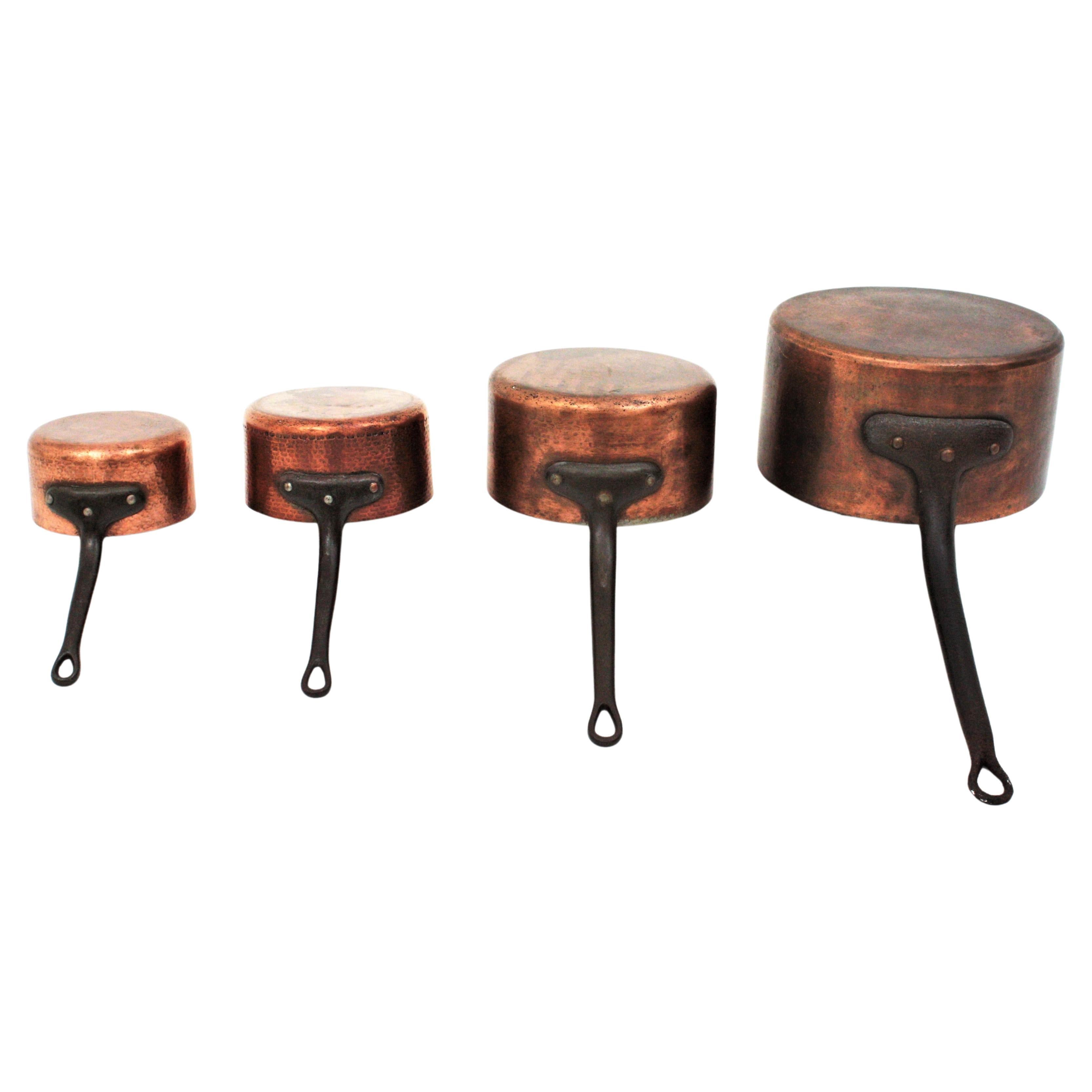 Great collection of antique french graduated hand-forged copper and cast iron cook pans - pots. France, late 19th century to 1930s.
The copper pots have cast iron handles. 
This set of four matching pots have been restored without polishing the