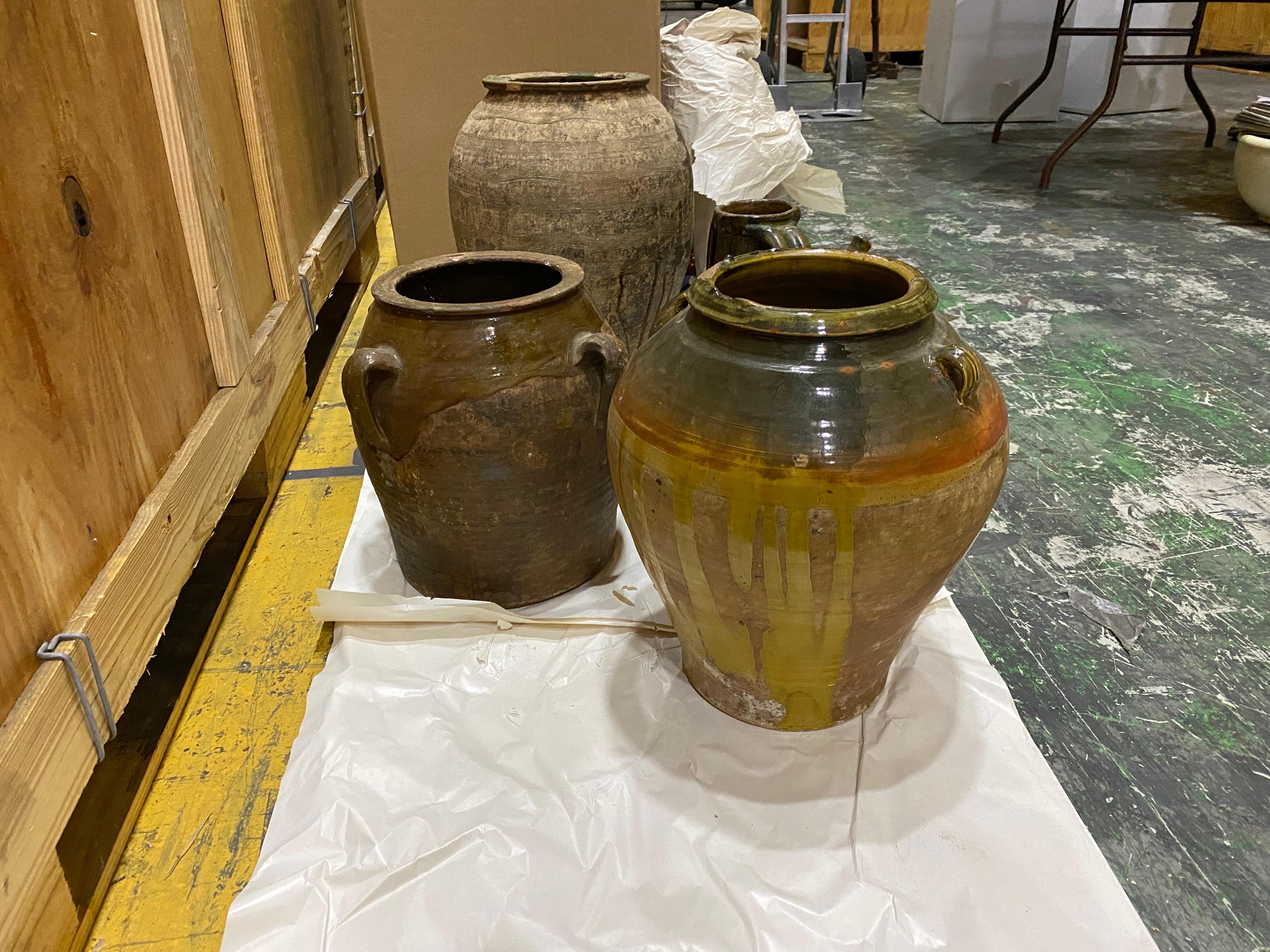 Set of Four French Green & Brown Glazed Terracotta Pots & Jars, 19th Century
Large Green glazed terracotta vessel unglazed with green glaze on the inside and dripped around the tops down the sides. One side principally unglazed. grooved design event