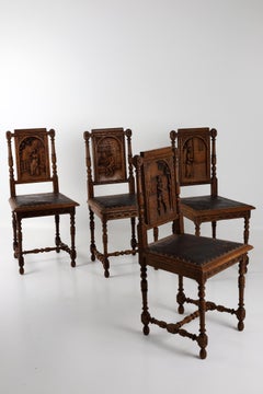 Set of Four French Henri II Carved Oak Dining Chairs with Figural Panels, Circa