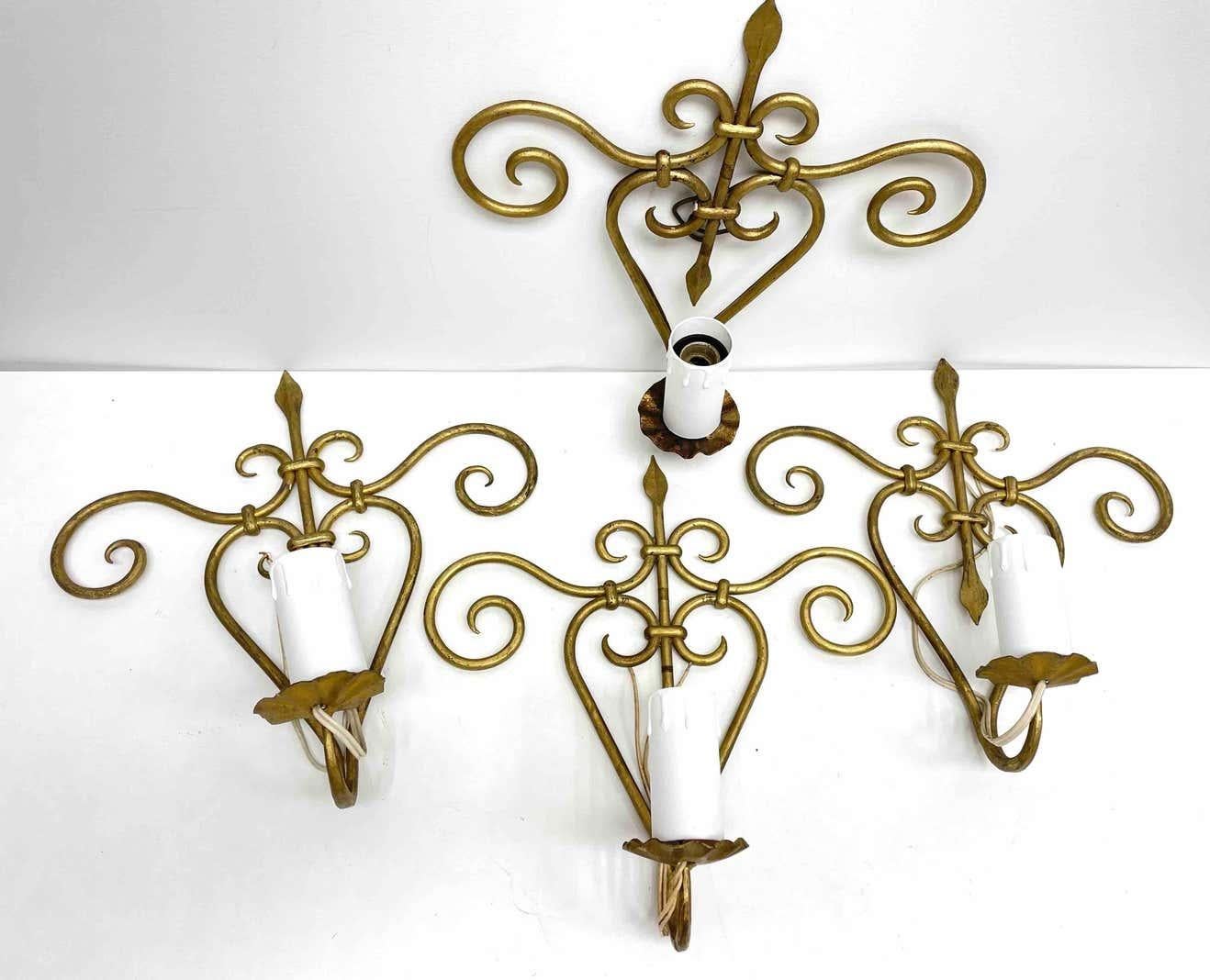 Two pair Hollywood Regency midcentury gilt floral tole sconces, each Fixture requires one European E27 / 110 Volt Edison bulbs, up to 60 watts. The wall lights have a beautiful patina and give each room an eclectic statement.