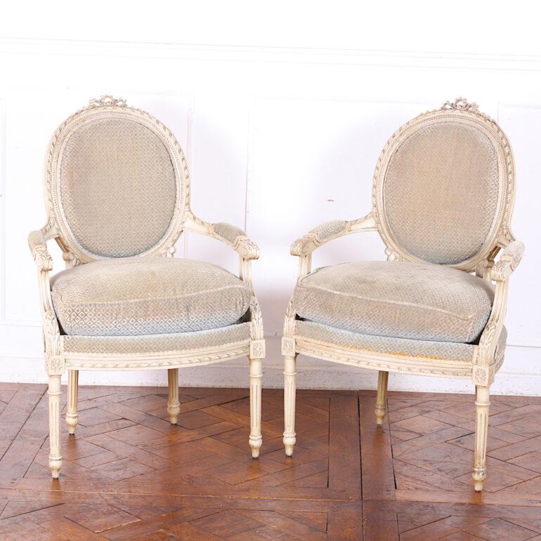 Set of four French carved and painted Louis XVI style fauteuils or open armchairs, the frames with finely-carved ribbon details and standing on turned tapering fluted legs. C. 1910.



 